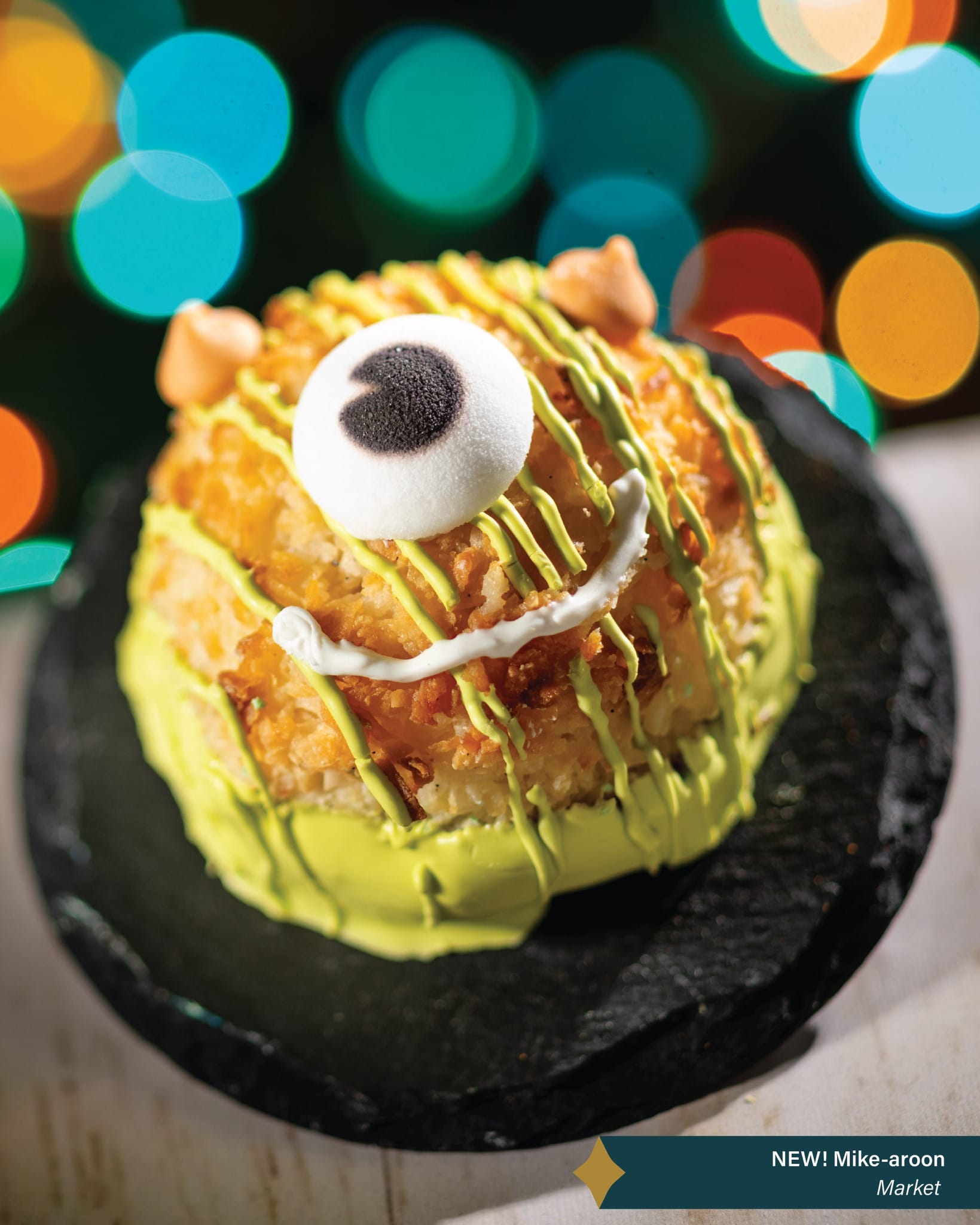 Mike Wazowski-themed round pastry with green icing, a fun treat for Jollywood Nights at Walt Disney World—no castle in sight.