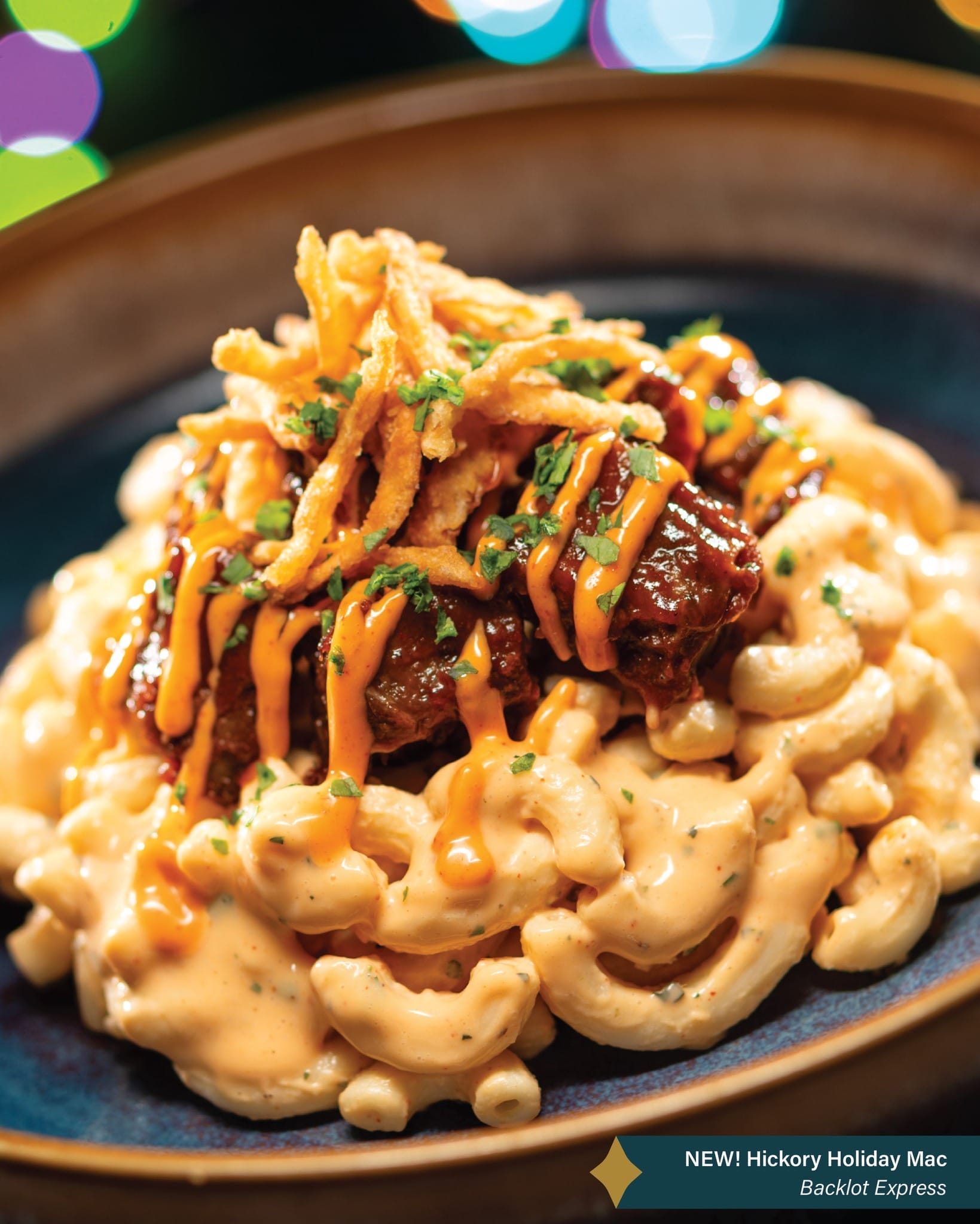 Macaroni and cheese with saucy meat, crispy onions, and orange sauce at Disney Jollywood Nights—no castle in this dish!