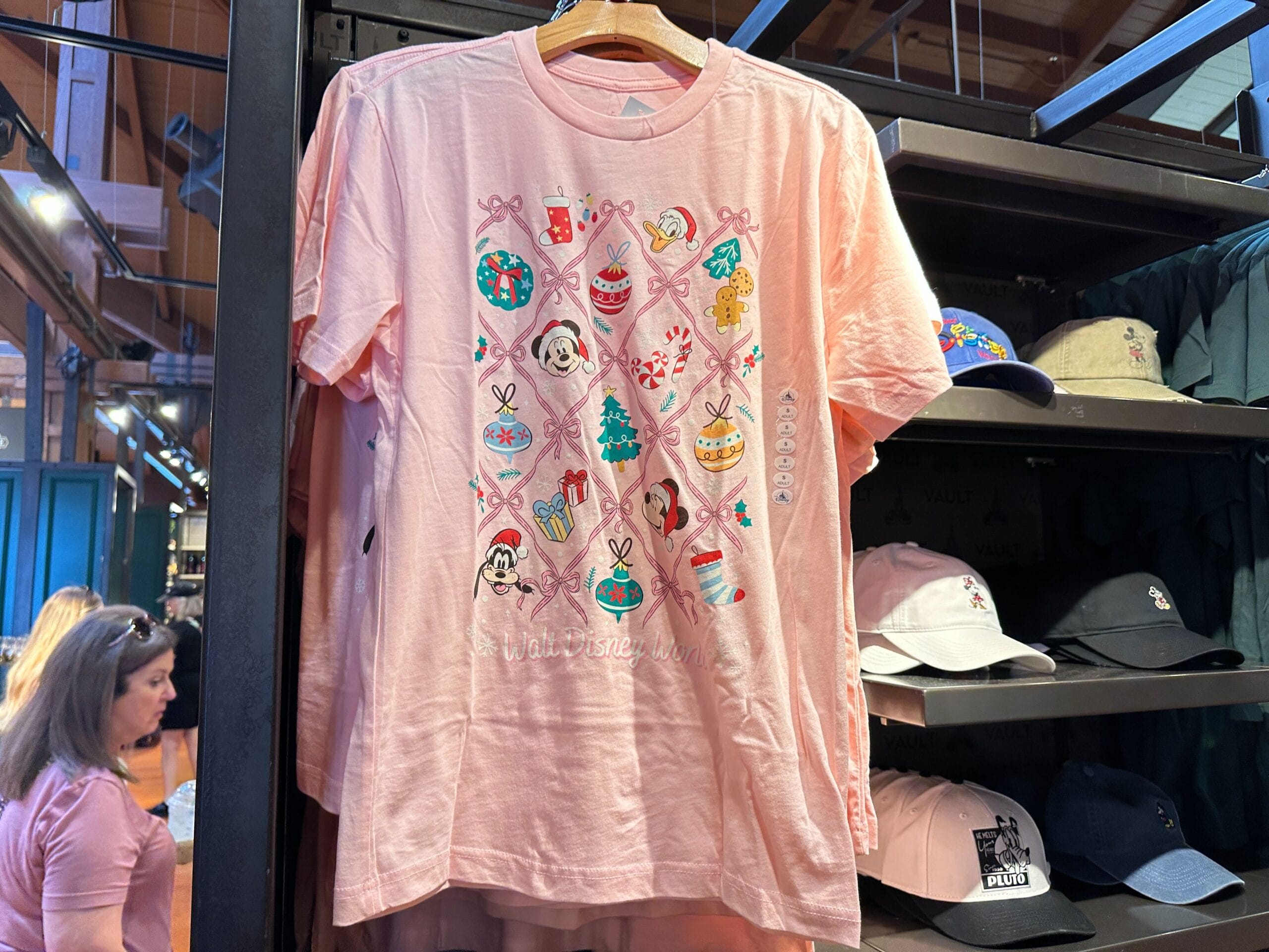 Pink Holiday Tees with Disney Christmas designs, showing Mickey, Minnie, ornaments, and treats like those found at Disney Parks worldwide.