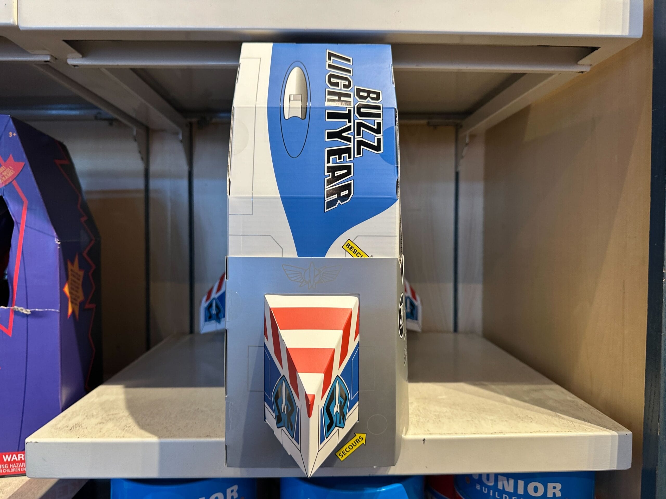 Toy Story 30th Anniversary box with Buzz Lightyear logo and spaceship, spotted on a shop shelf at a Disney park. No castle pictured.