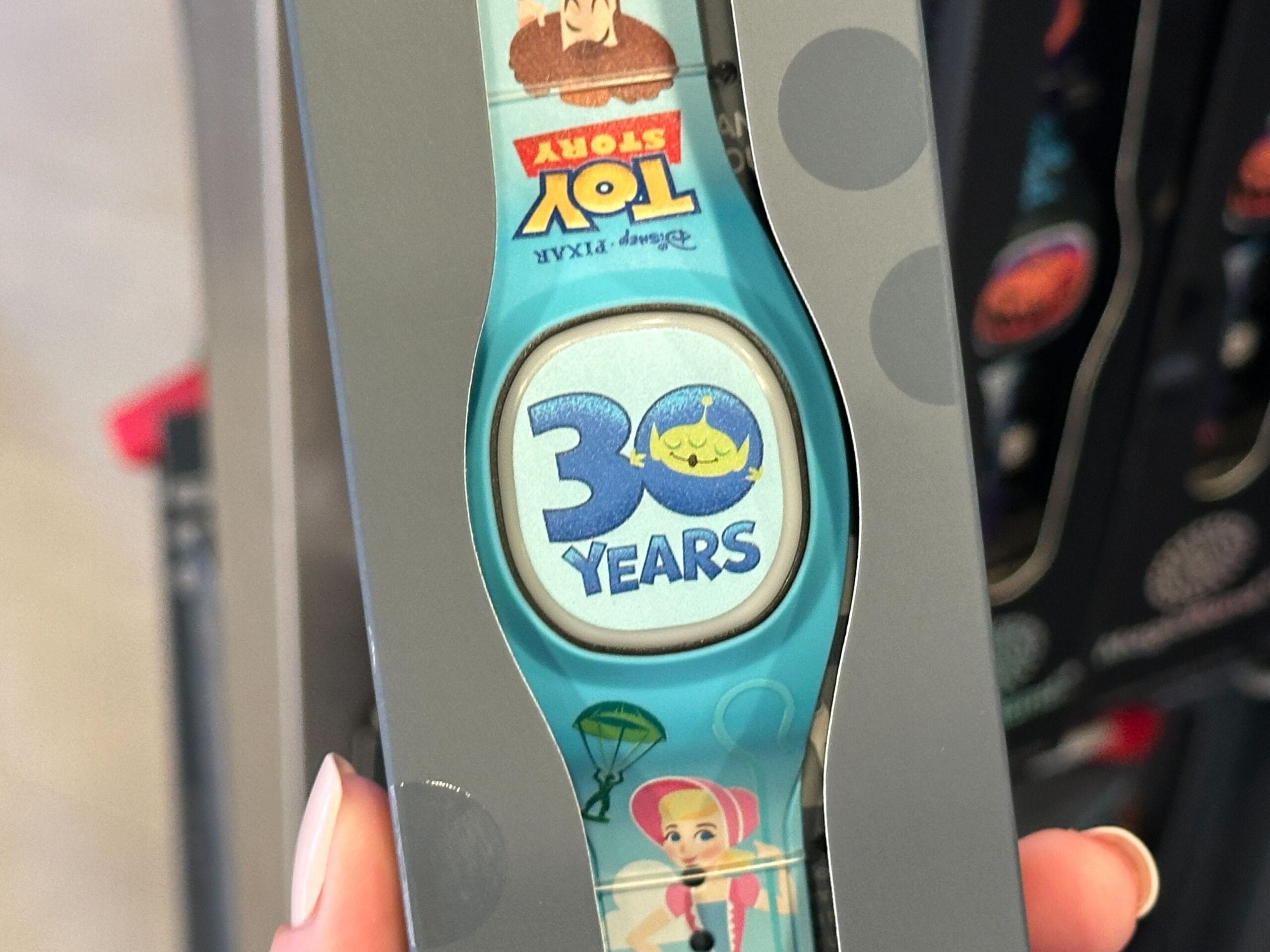 Close-up of a Toy Story-themed MagicBand+ wristband featuring "30 Years" and Toy Story characters.