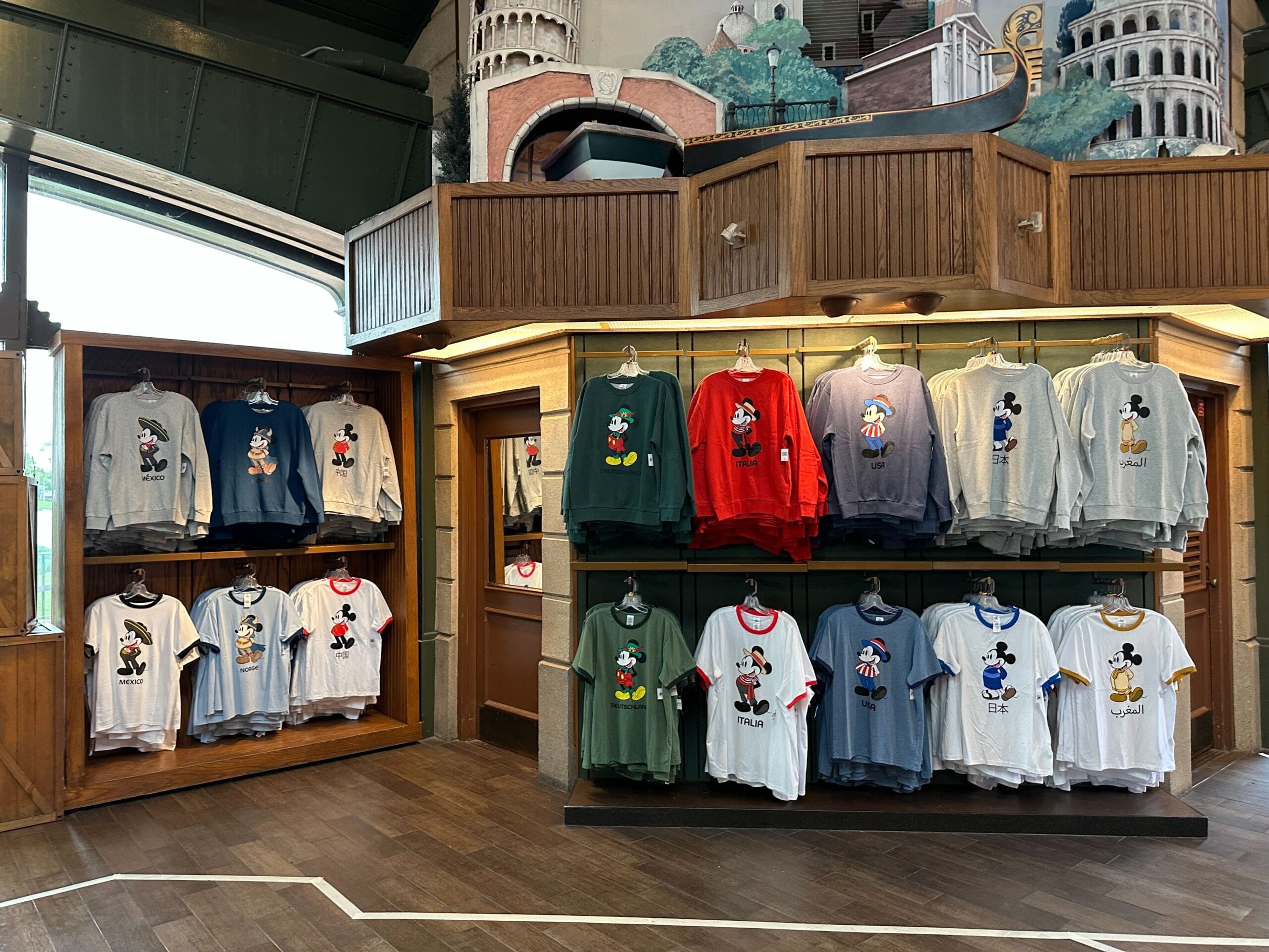 Disney-themed Sweatshirt Collection featuring Mickey Mouse and Minnie displayed on shelves in a wooden store interior.