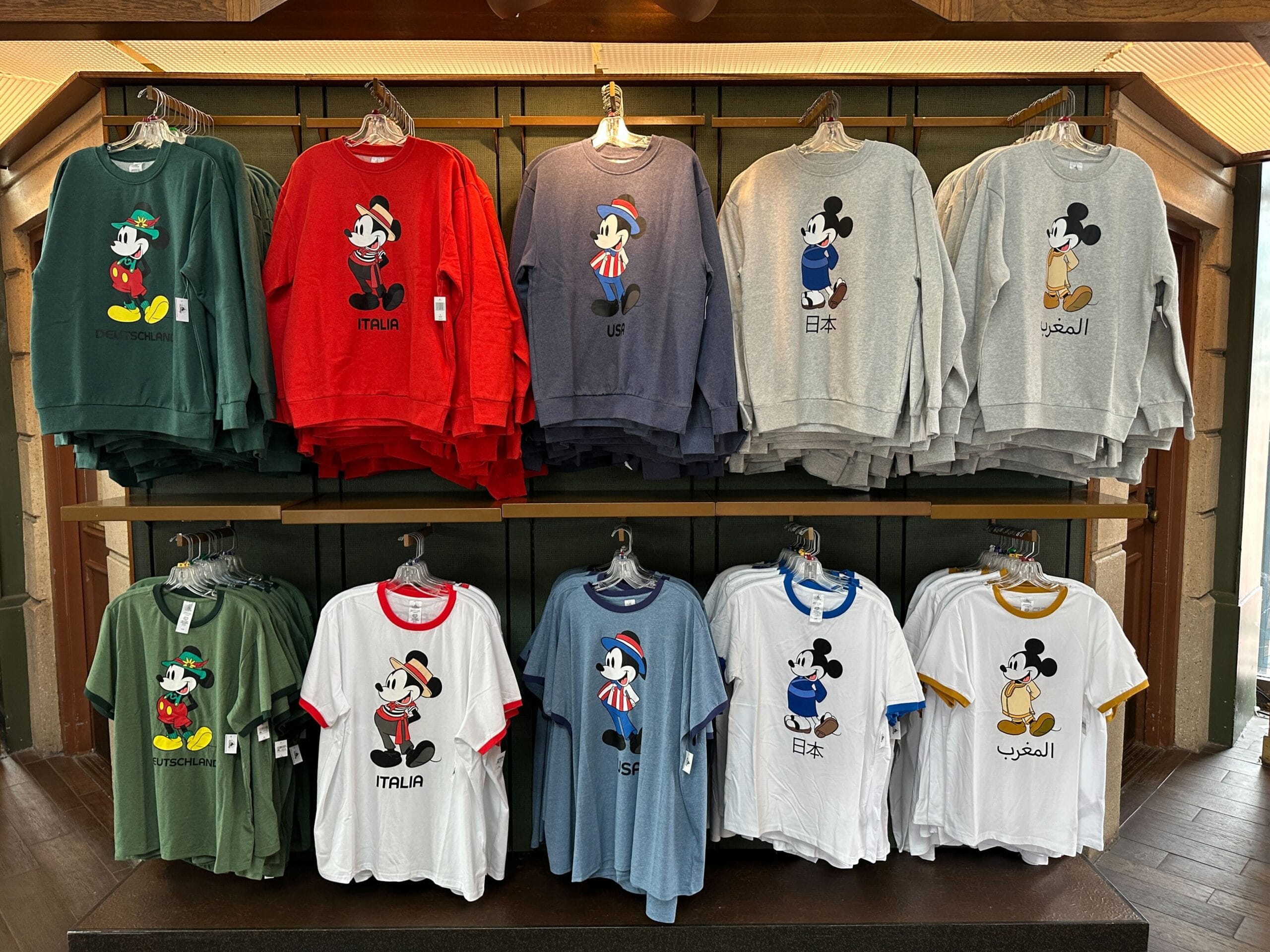 EPCOT display of Mickey Mouse shirts in various colors, each labeled with a different country name in various languages.