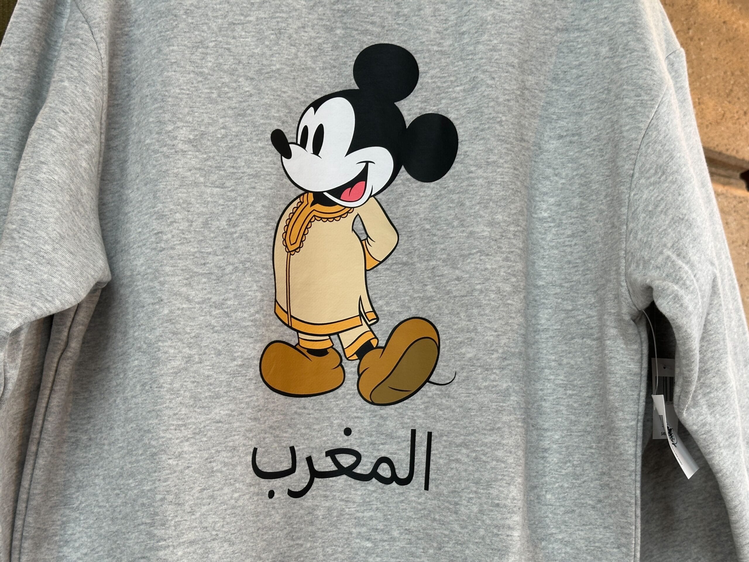 Gray Sweatshirt Collection piece featuring Mickey Mouse in Moroccan attire, with "Morocco" in Arabic below.