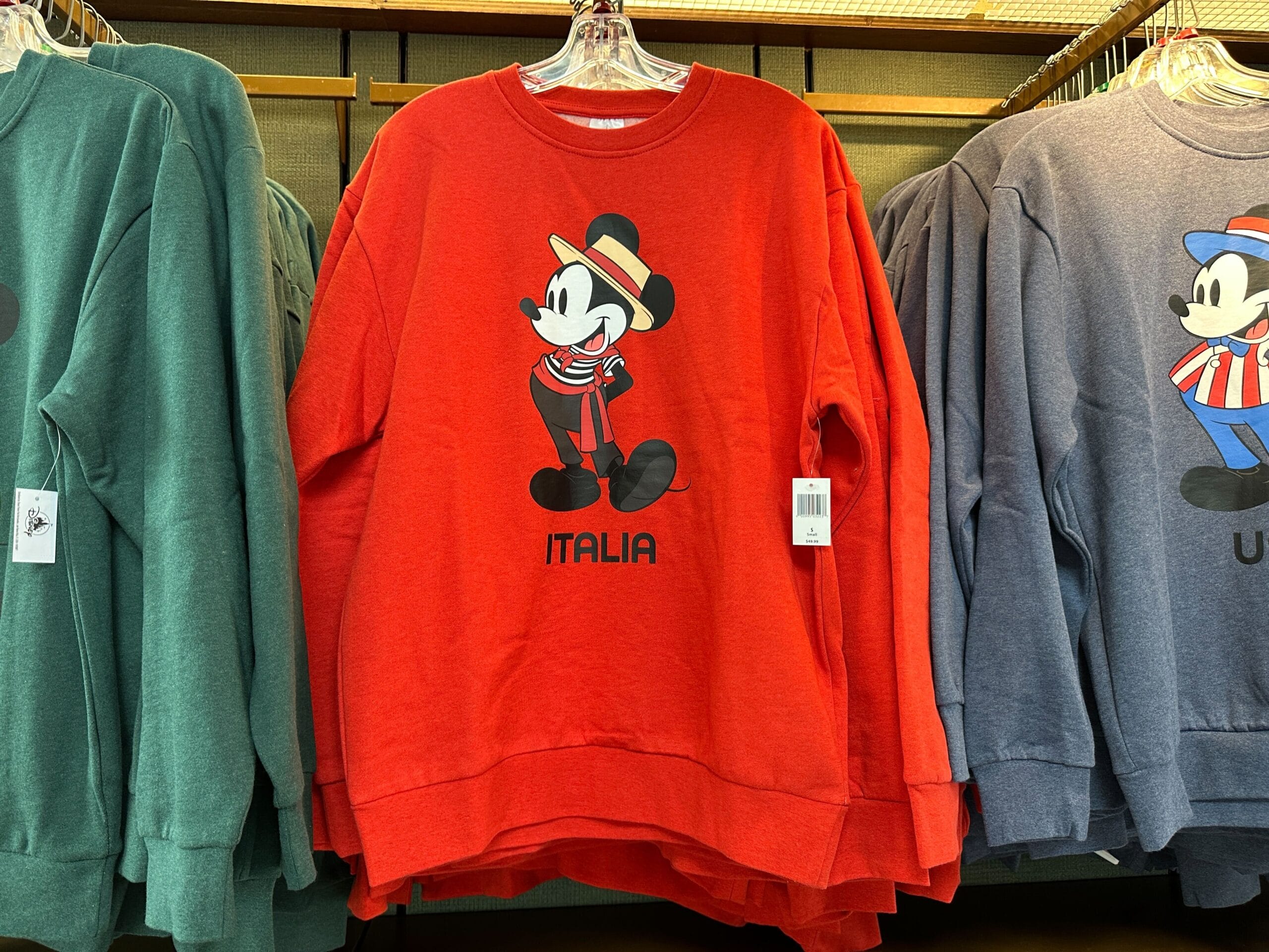 Red sweatshirt from the EPCOT Sweatshirt Collection featuring Mickey Mouse in Italian attire and "ITALIA" printed below.