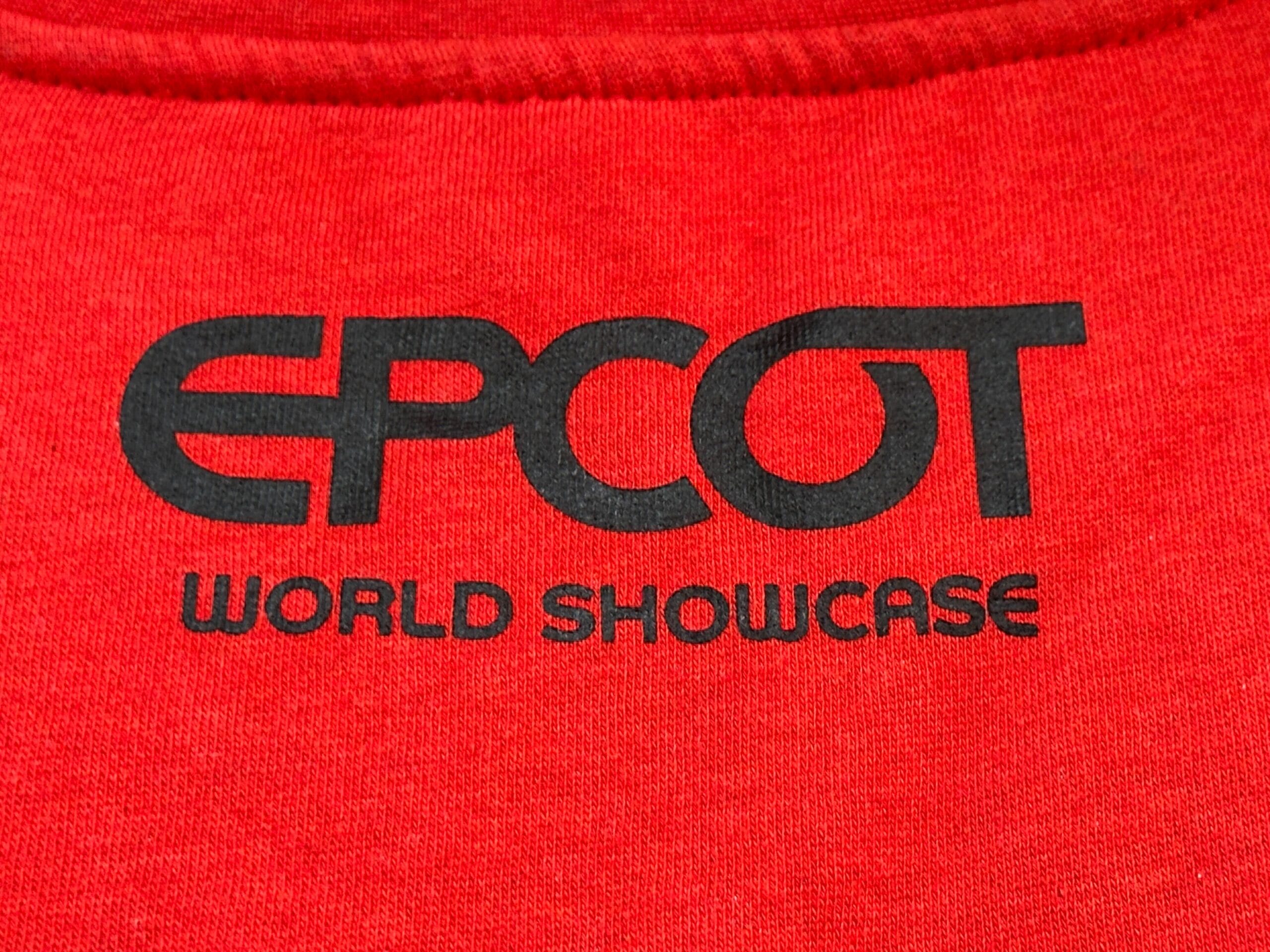 Red sweatshirt from the EPCOT Sweatshirt Collection with black text and "WORLD SHOWCASE" printed below.