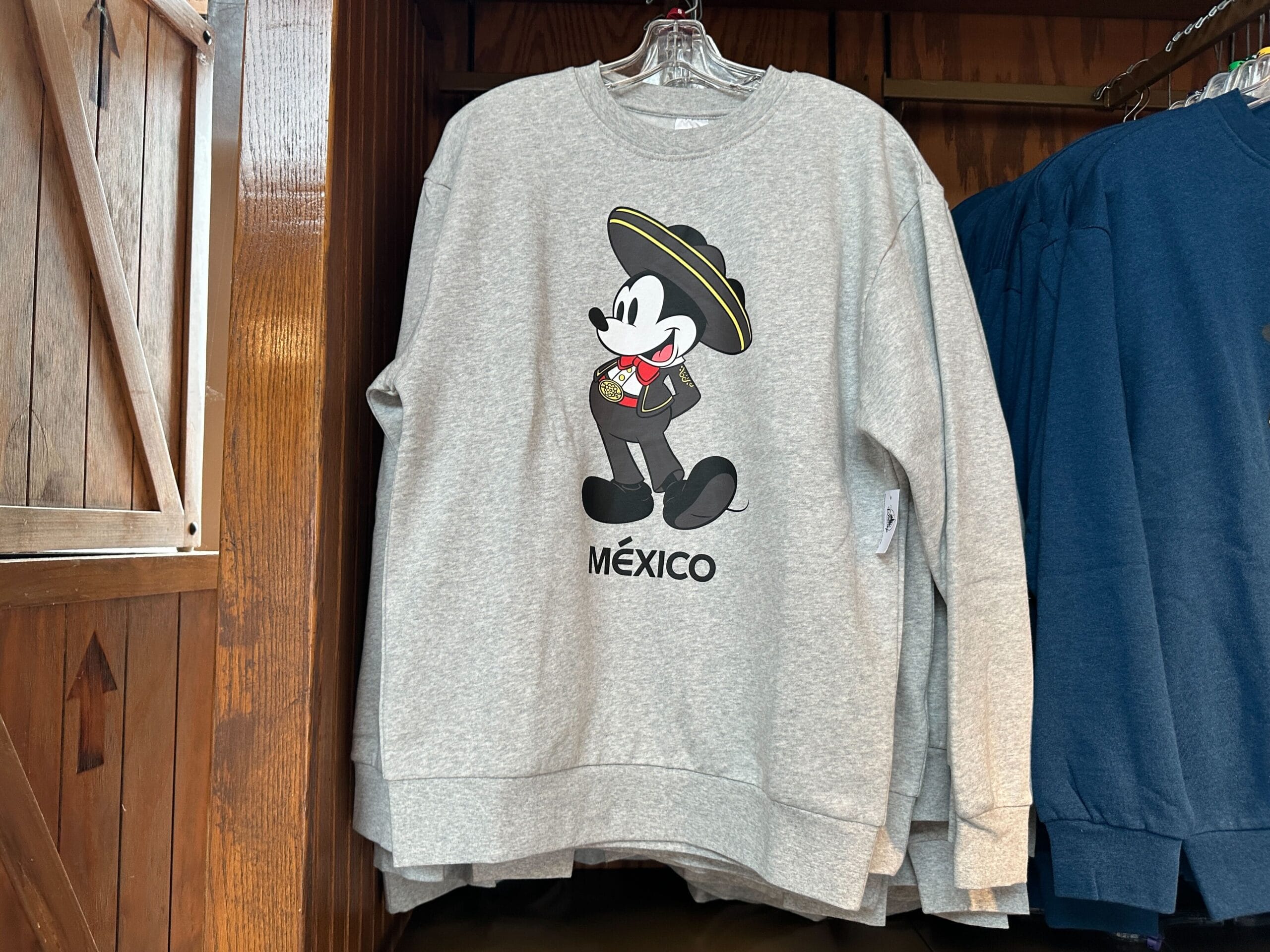Gray sweatshirt from the Sweatshirt Collection featuring Mickey Mouse in a charro outfit, sombrero, and "México" text.