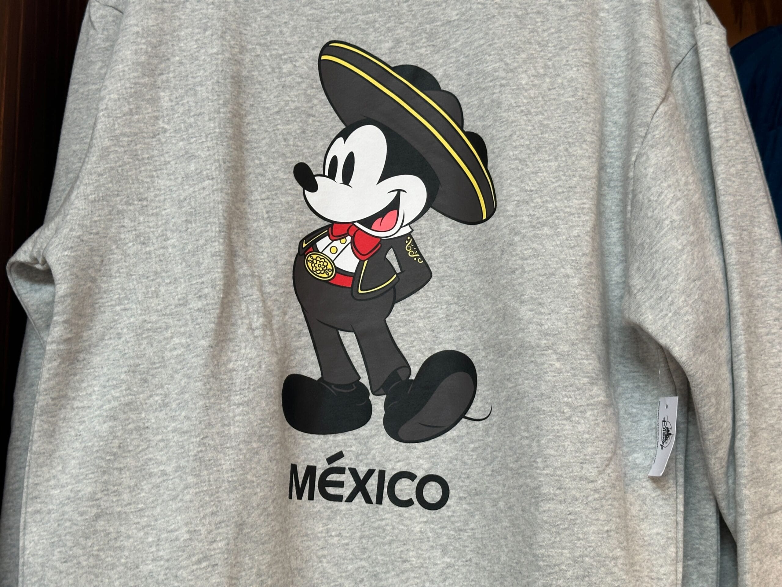 Mickey Mouse in a mariachi outfit and sombrero with "MÉXICO" below on an EPCOT World Showcase Sweatshirt.