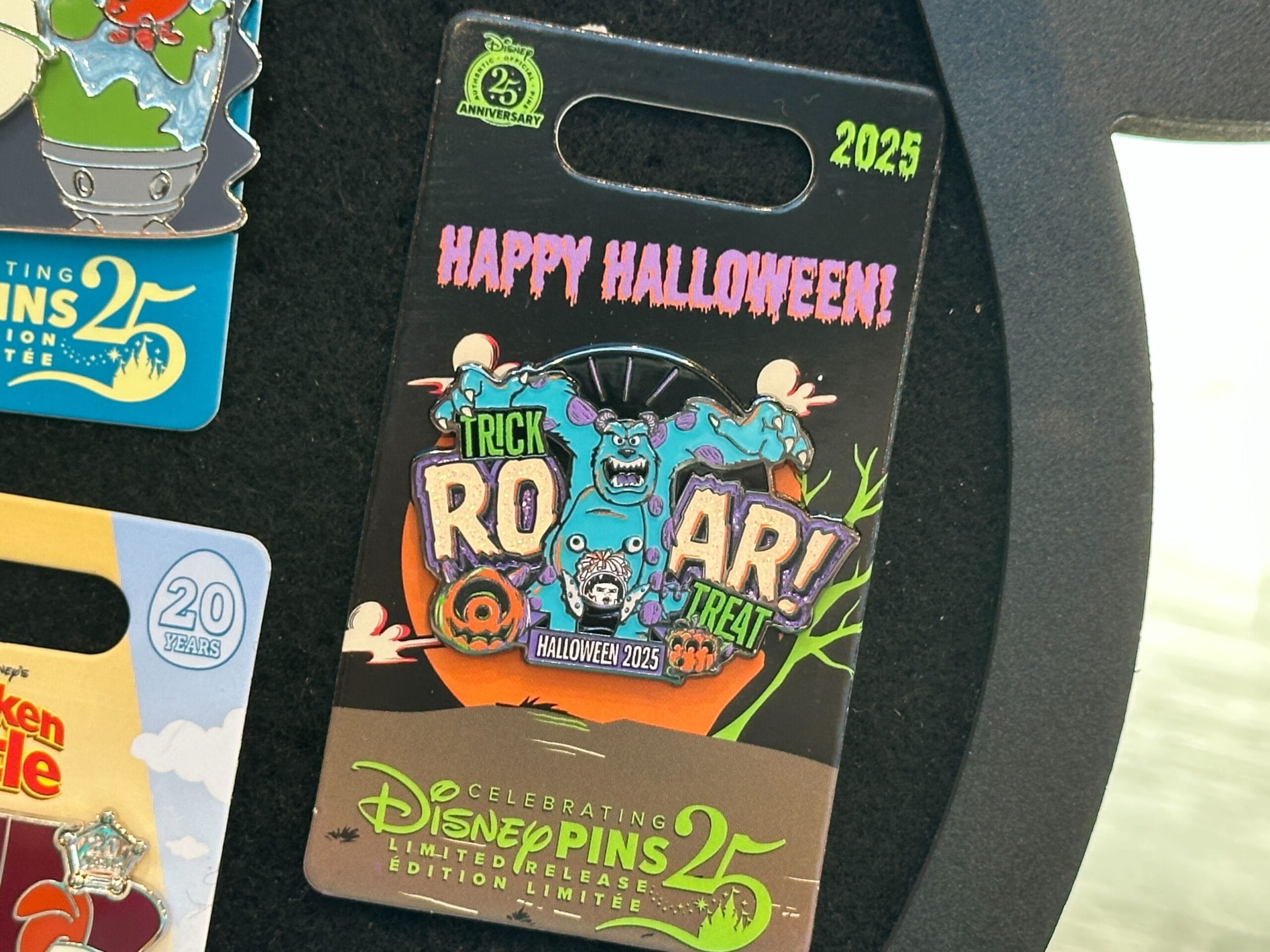 Disney World Halloween pin featuring "ROAR!" and Monsters, Inc. characters for Disney Pins' 25th anniversary in 2025