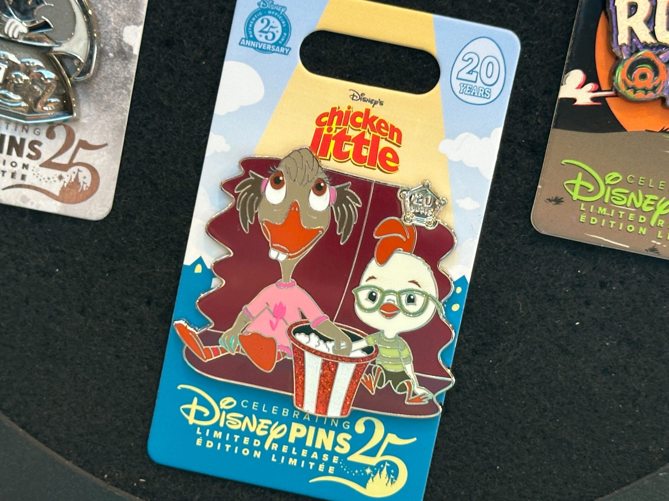 Disney Chicken Little pin with two characters eating popcorn, celebrating 25 years of Disney Pins