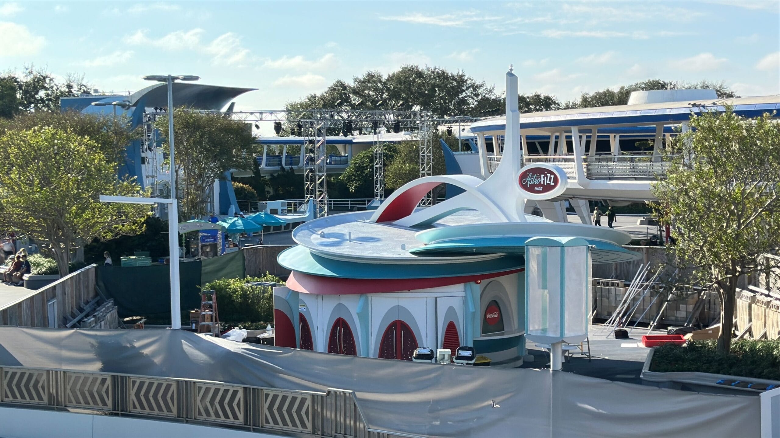 A retro-futuristic building by Magic Kingdom, with a round roof and rocket-like spire, trees around—unlike any Disney castle.