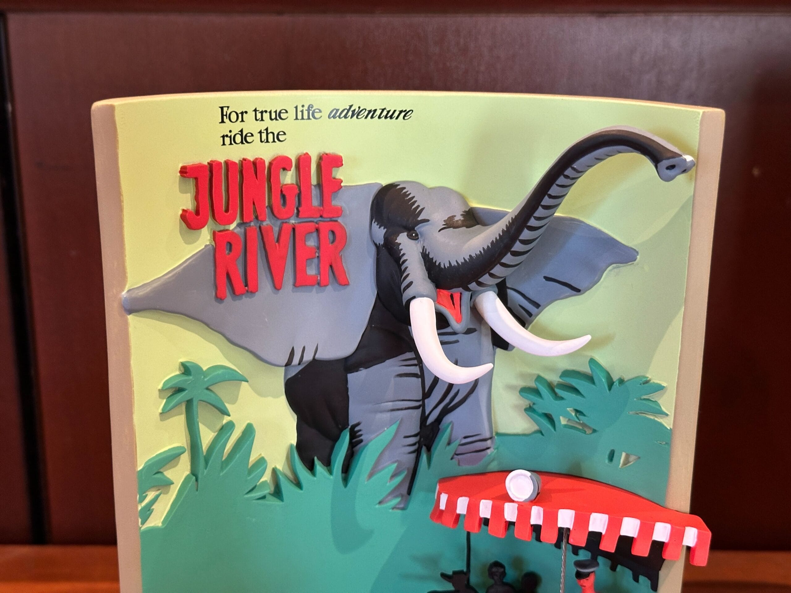 A 3D sign featuring an elephant and "JUNGLE RIVER" text, inspired by Disney World's Jungle Cruise adventure.
