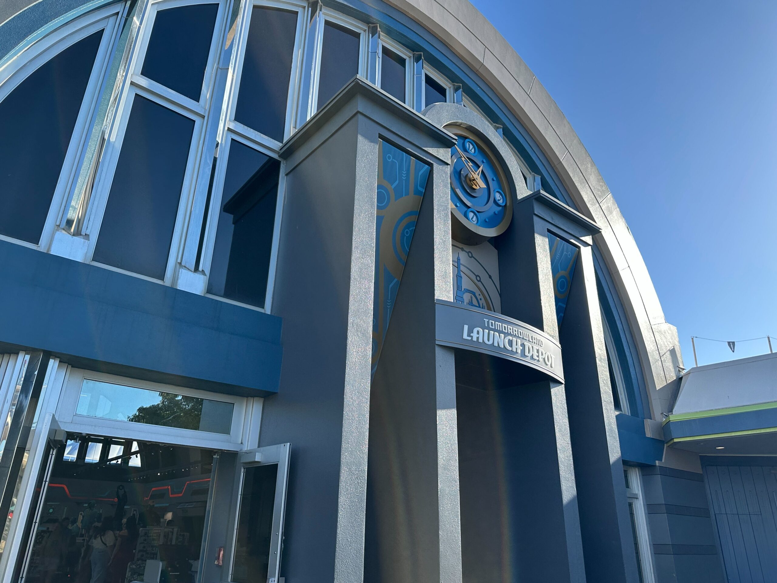 Tomorrowland Launch Depot at Disney World features arched windows and blue-gray walls, distinct from any worldwide Disney castle design.