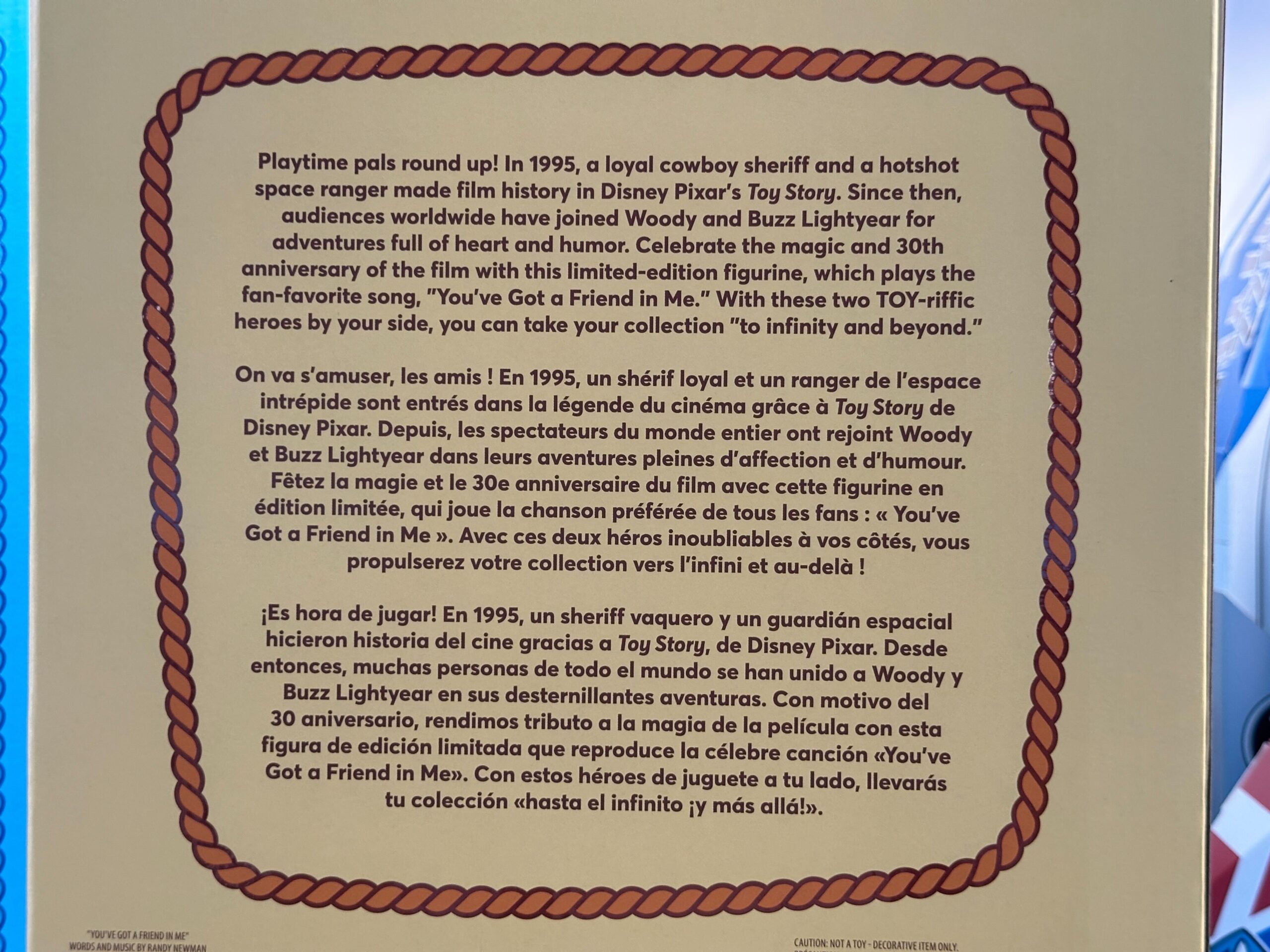 Multilingual text celebrates Toy Story 30th Anniversary with Woody and Buzz; imagery reminiscent of Disney park festivities.