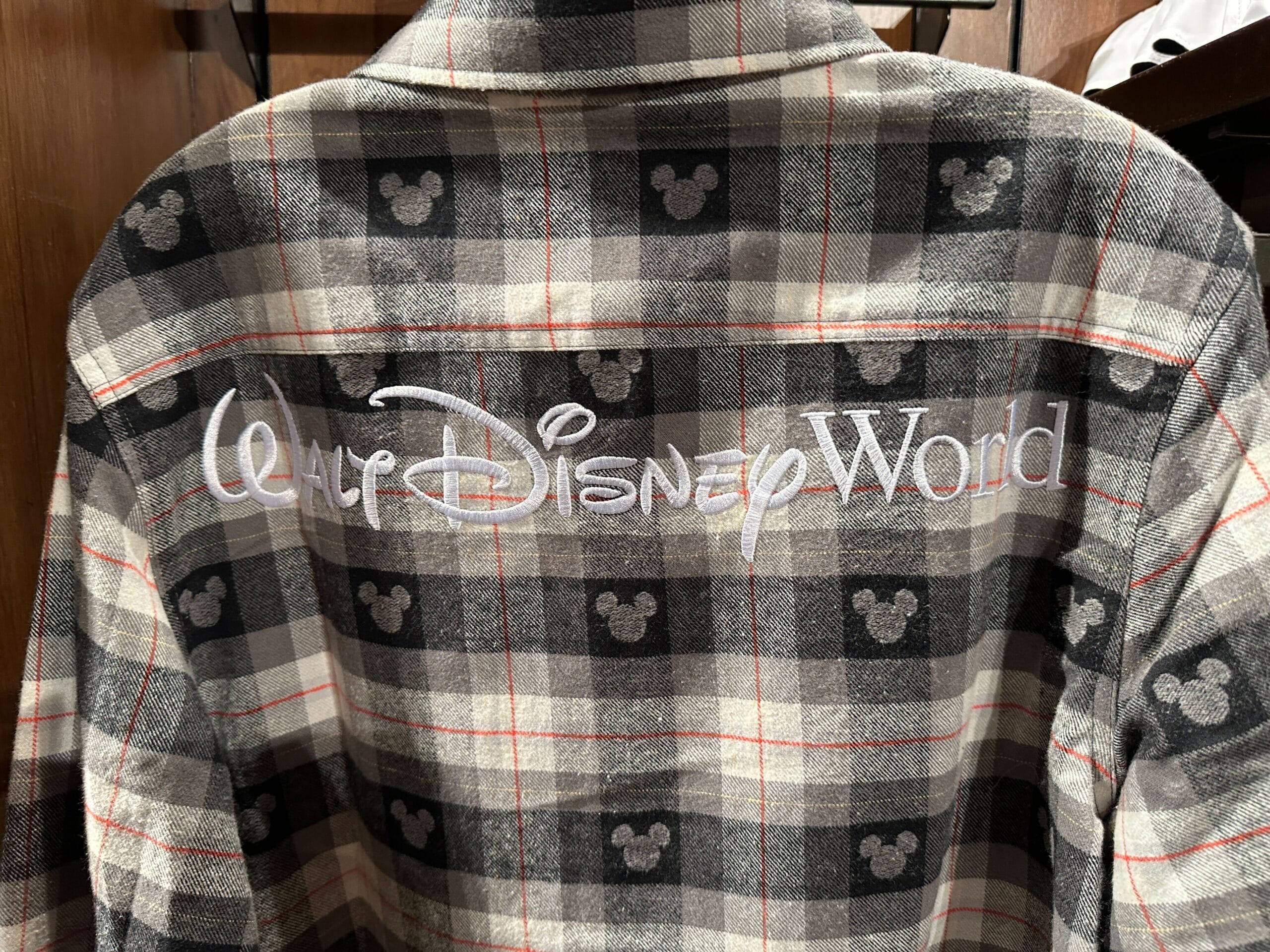 Gray plaid shirt featuring tiny Mickey Mouse icons, with "Walt Disney World" in white embroidery on the back, referencing the Florida park.
