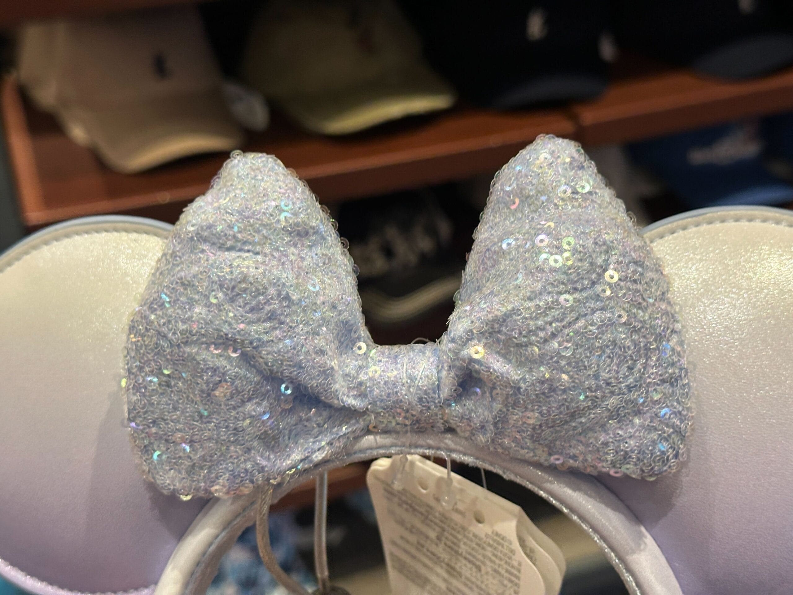 Close-up of a shimmering lavender sequin bow on a pearly blue Disney ear headband at Port Orleans Riverside Resort.