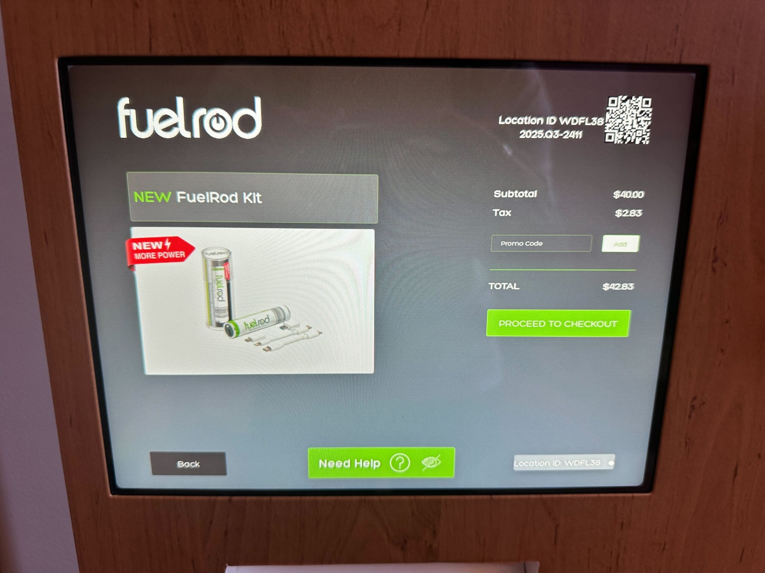 Touchscreen at a Disney park displays FuelRod Kit purchase info—price, subtotal, tax, and “Proceed to Checkout” button shown.