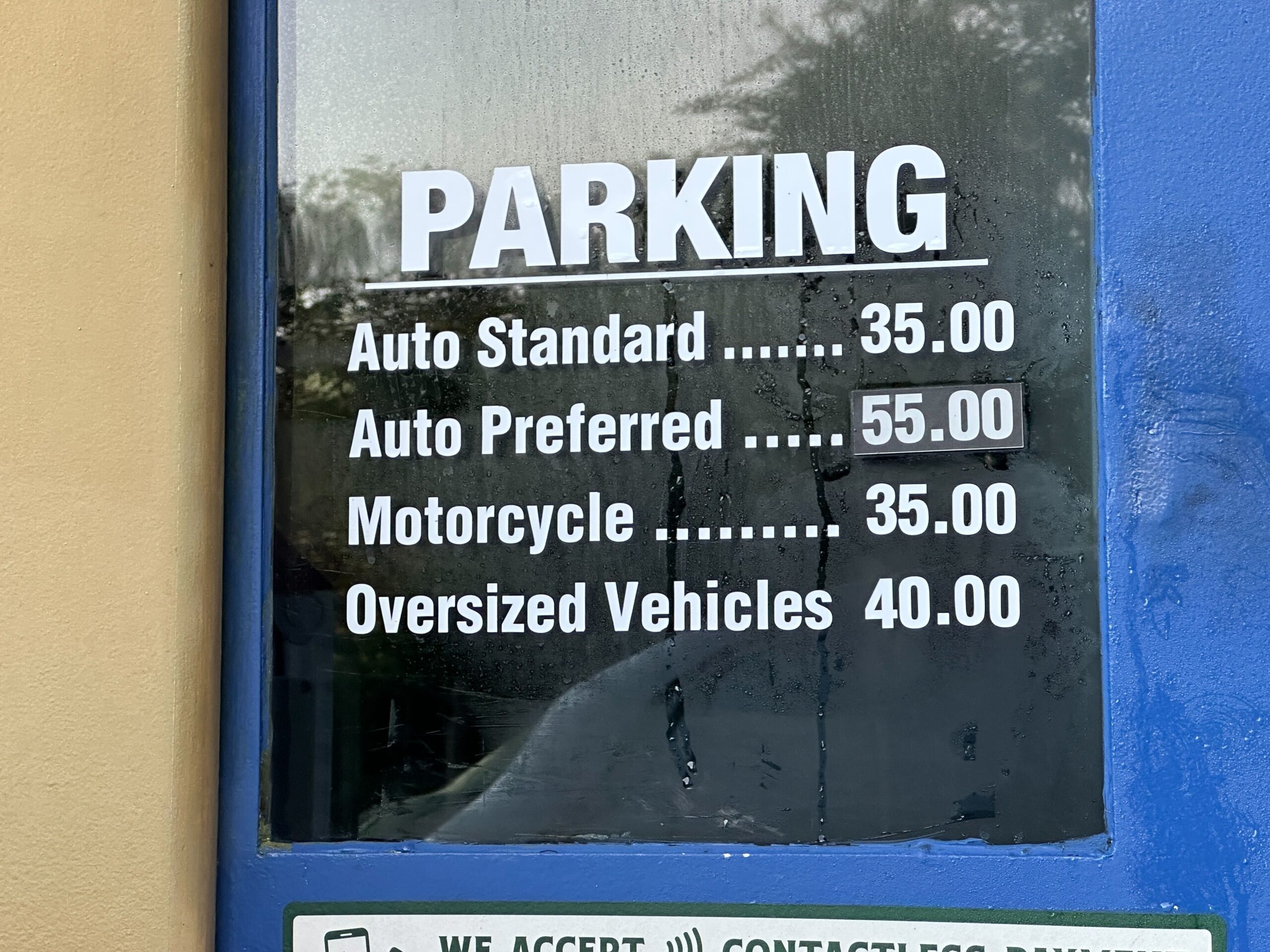 Disney park parking rates sign: Auto Standard $35, Preferred $55, Motorcycle $35, Oversized $40—prices similar to Walt Disney World.