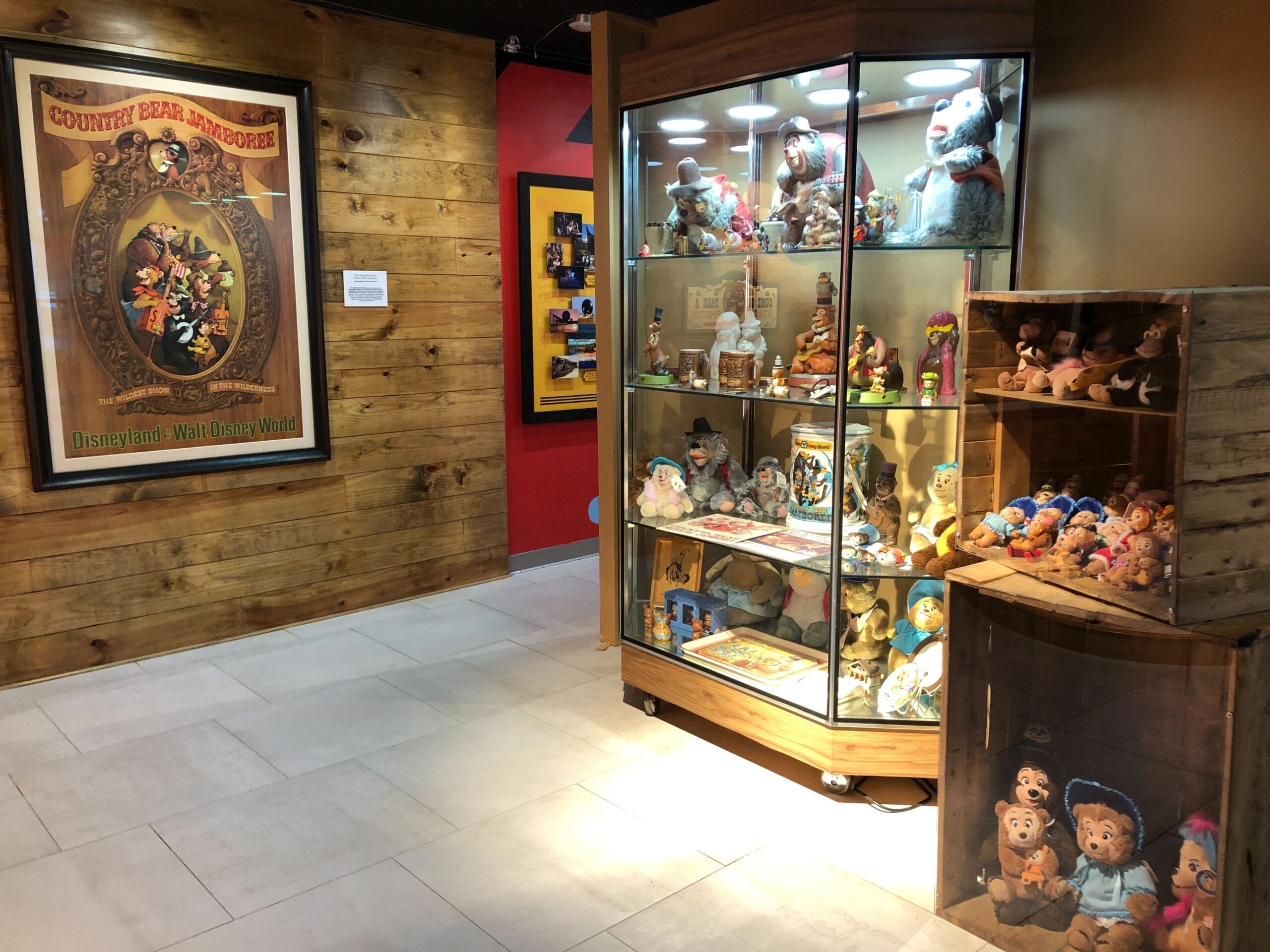 A display case and shelves showcase vintage Disneyland Country Bear collectibles in the Disney Theme Park Museum in Celebration, Florida.