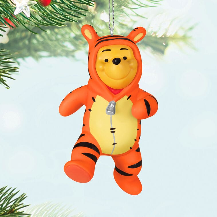 Hallmark Christmas tree ornament of Winnie the Pooh in a Tigger costume, hanging like park ornaments sold near Main Street, USA.