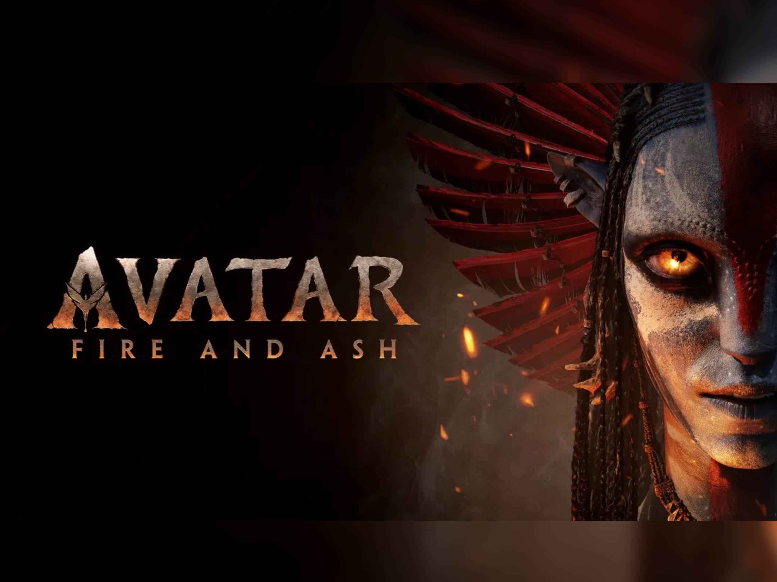 Half of a Na’vi face with glowing eyes, red headdress; "Avatar: Fire and Ash" title, dark background like Pandora at Animal Kingdom.
