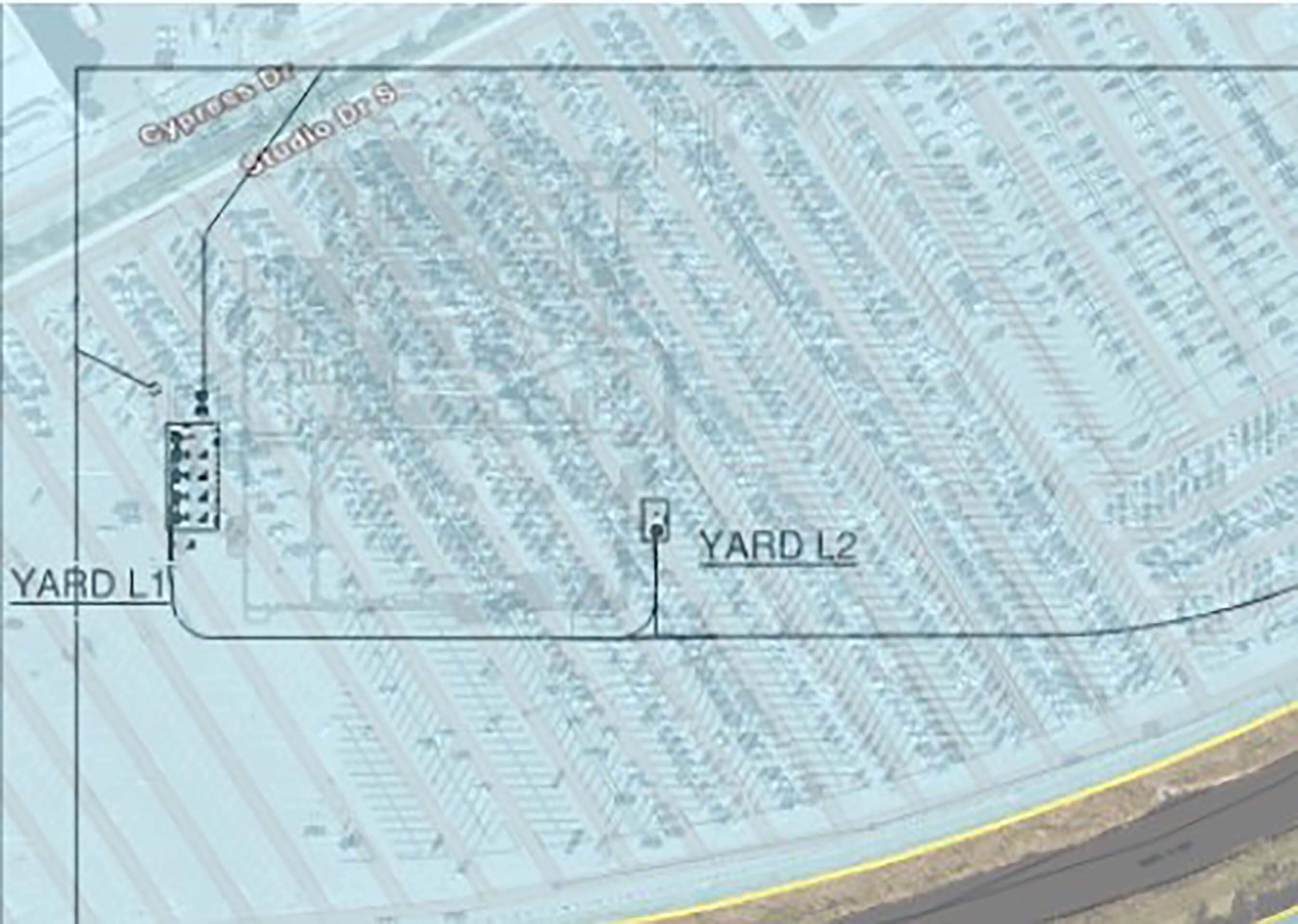 A map of a yard with the Building Outline next to the Monsters Inc. Coaster, similar to layouts seen in Disney theme parks worldwide.