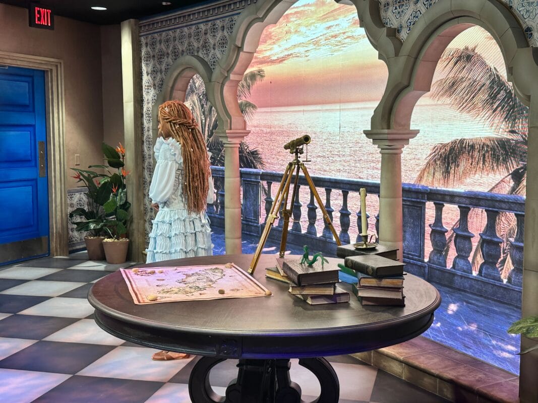 A woman in a white ruffled dress stands on a balcony at sunset in a Disney park, map and telescope ready, Cinderella Castle nearby.