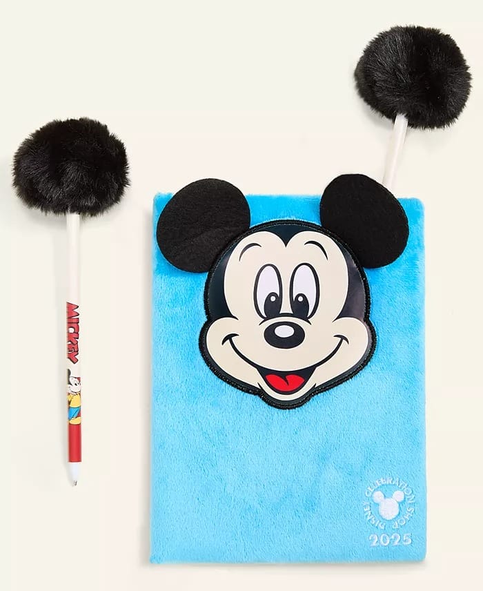 A blue furry Disney notebook with a Mickey Mouse face and two black fluffy pens from the Holiday Collection, reminiscent of park souvenirs.