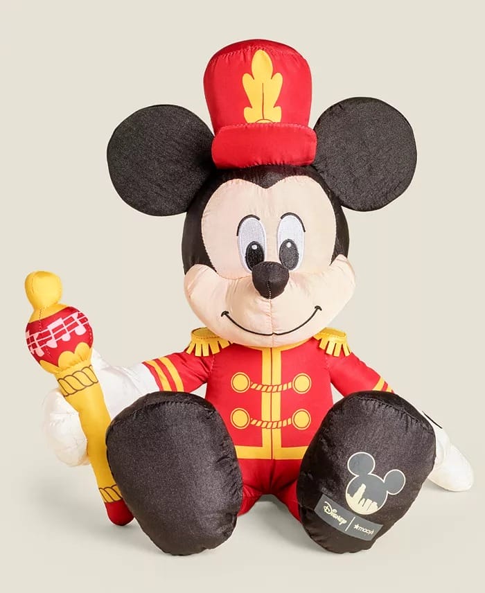 A plush Mickey Mouse toy in a marching band leader outfit, like outfits seen at Disney parks parades, holding a baton.