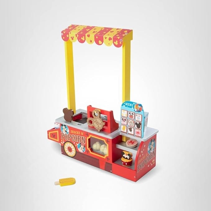 Colorful toy popcorn and snack stand with a striped canopy, perfect for a Disney-themed Big Deal Day on Amazon Prime.