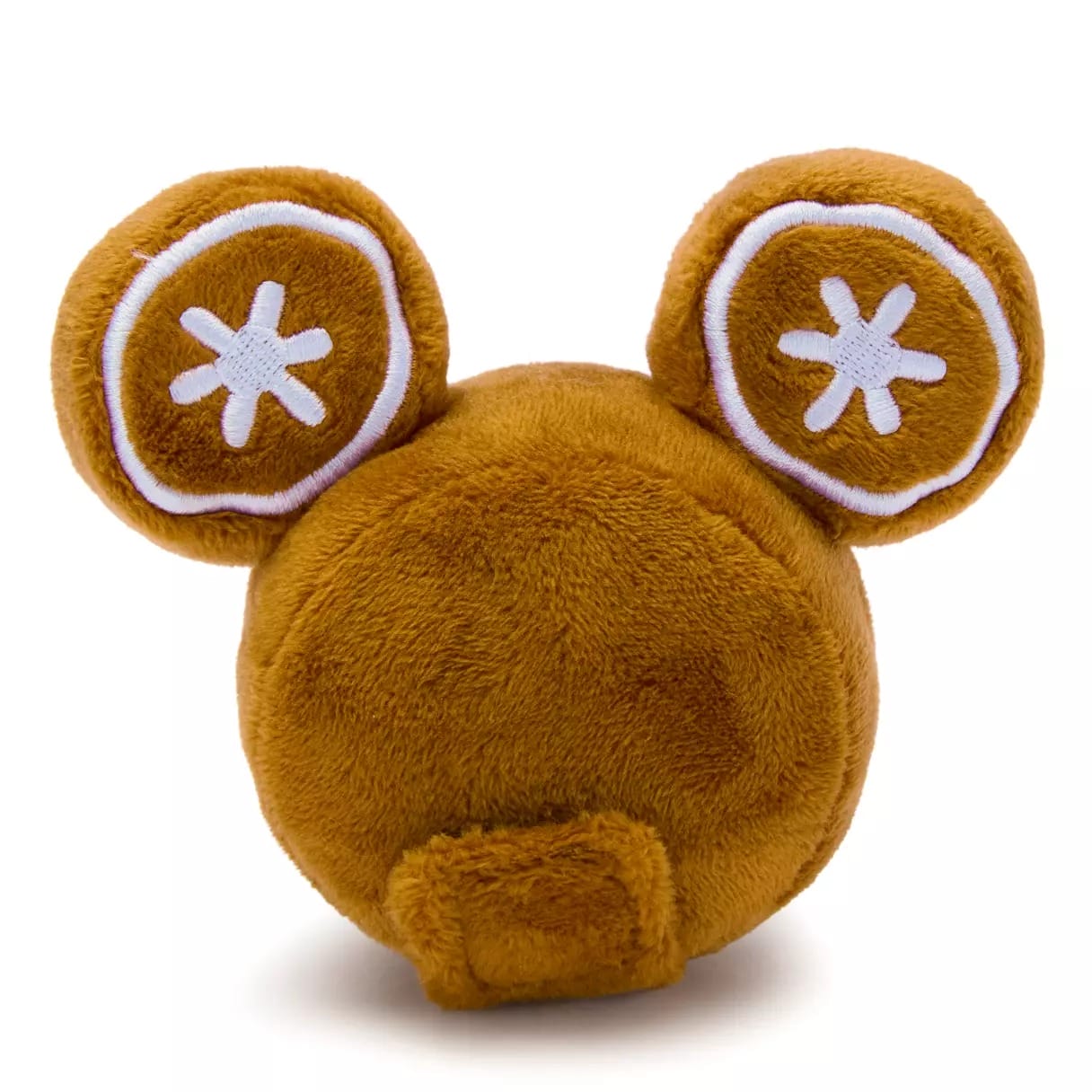 Round, brown plush toy with big ears decorated in white star-like patterns, resembling Disney park merchandise, with a small tail.