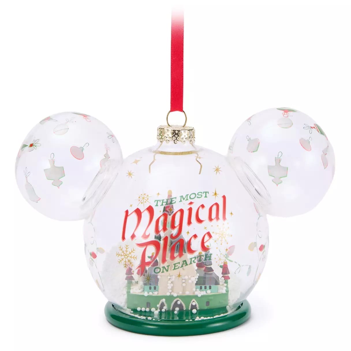 Clear ornament shaped like Mickey Mouse with "The Most Magical Place on Earth" and a castle design, hanging from a red ribbon.