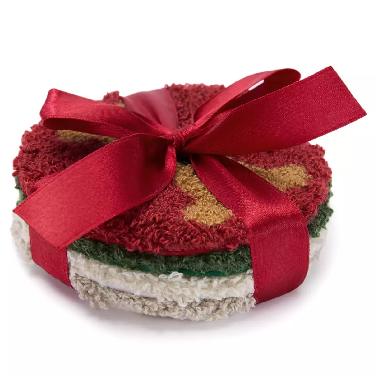 Stack of round, textured coasters tied with a red ribbon, featuring festive red, green, and white colors.