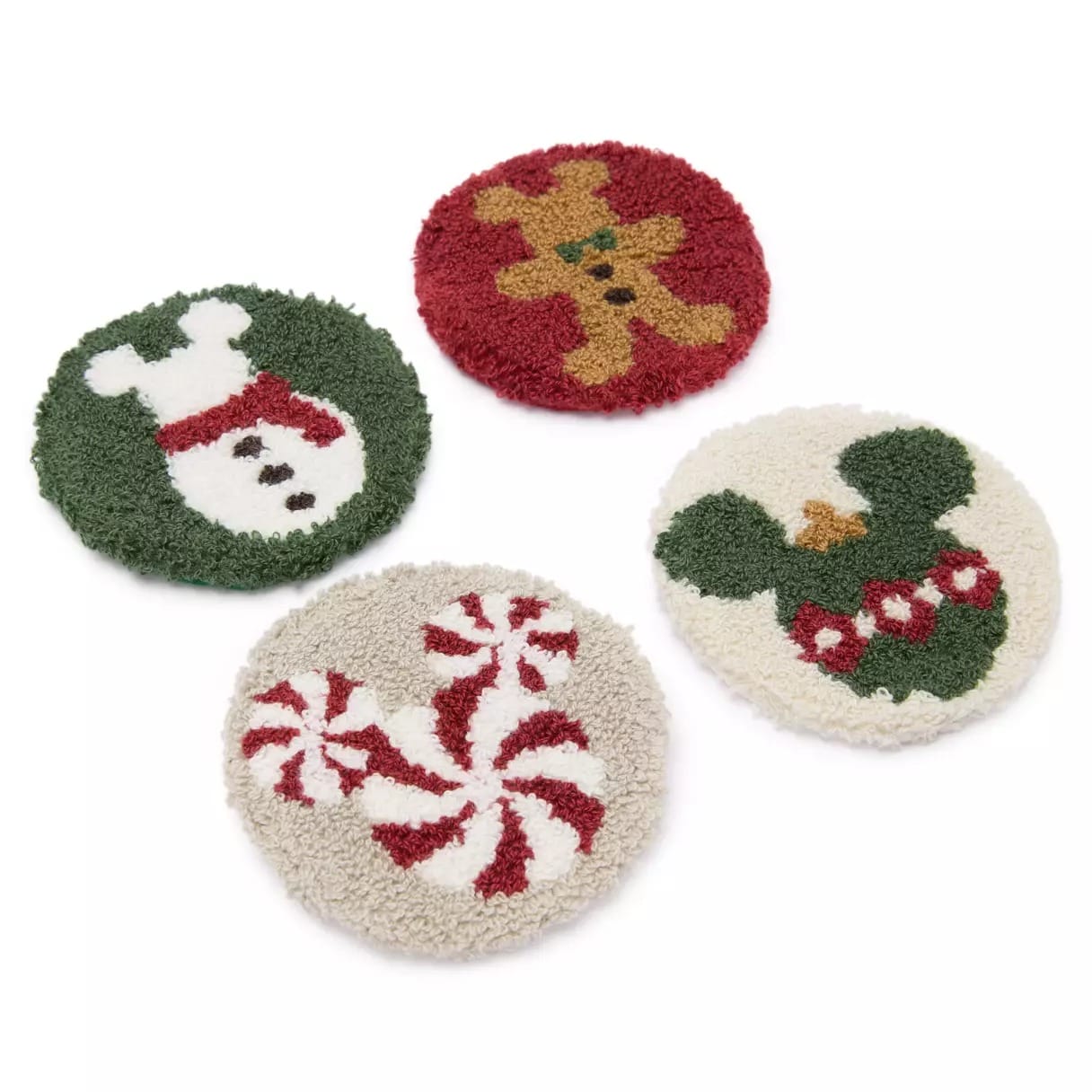 Four round holiday coasters featuring a snowman, gingerbread man, Mickey Mouse wreath, and peppermint candies.