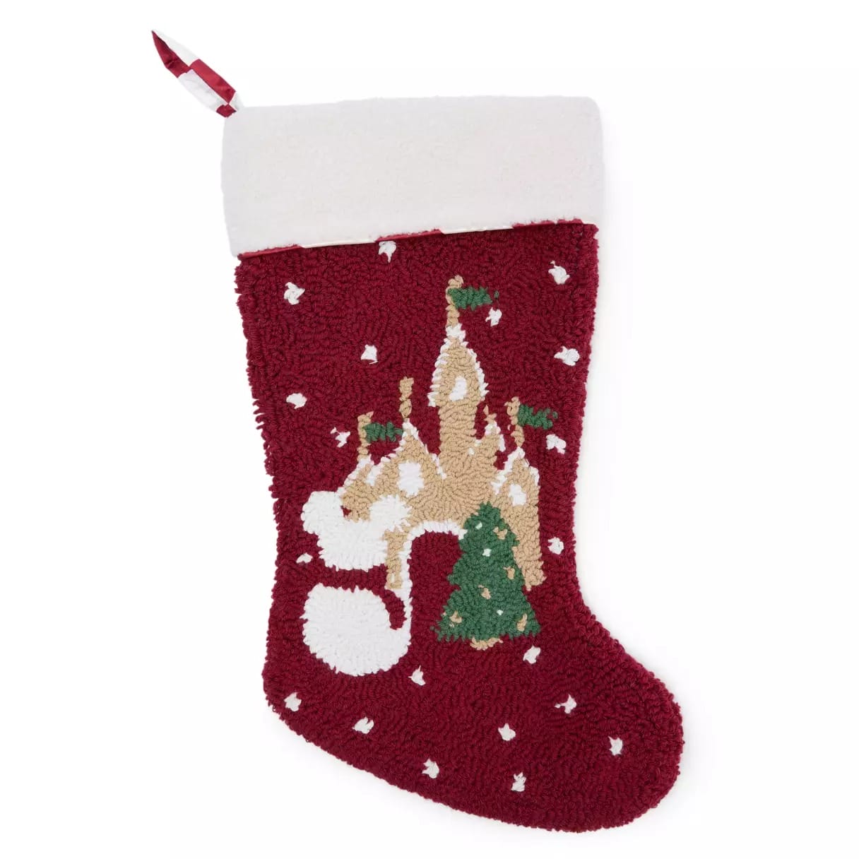 Red Christmas stocking with a white cuff, decorated with a castle, snowman, Christmas tree, and falling snow.
