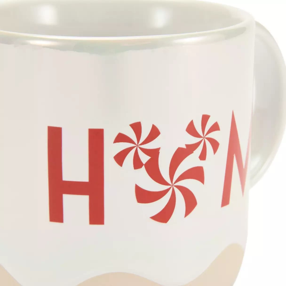 White mug with "H M" in red letters; two red peppermint candies form the letter "O" between them.