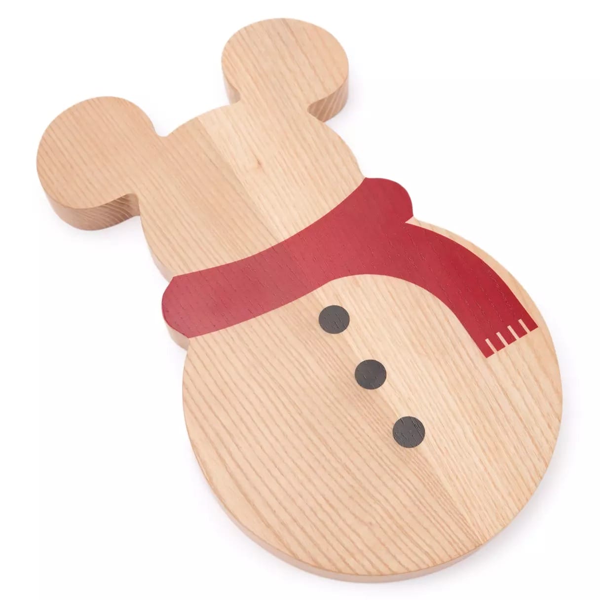 Wooden cutting board shaped like a snowman with mouse ears, painted with black buttons and a red scarf.