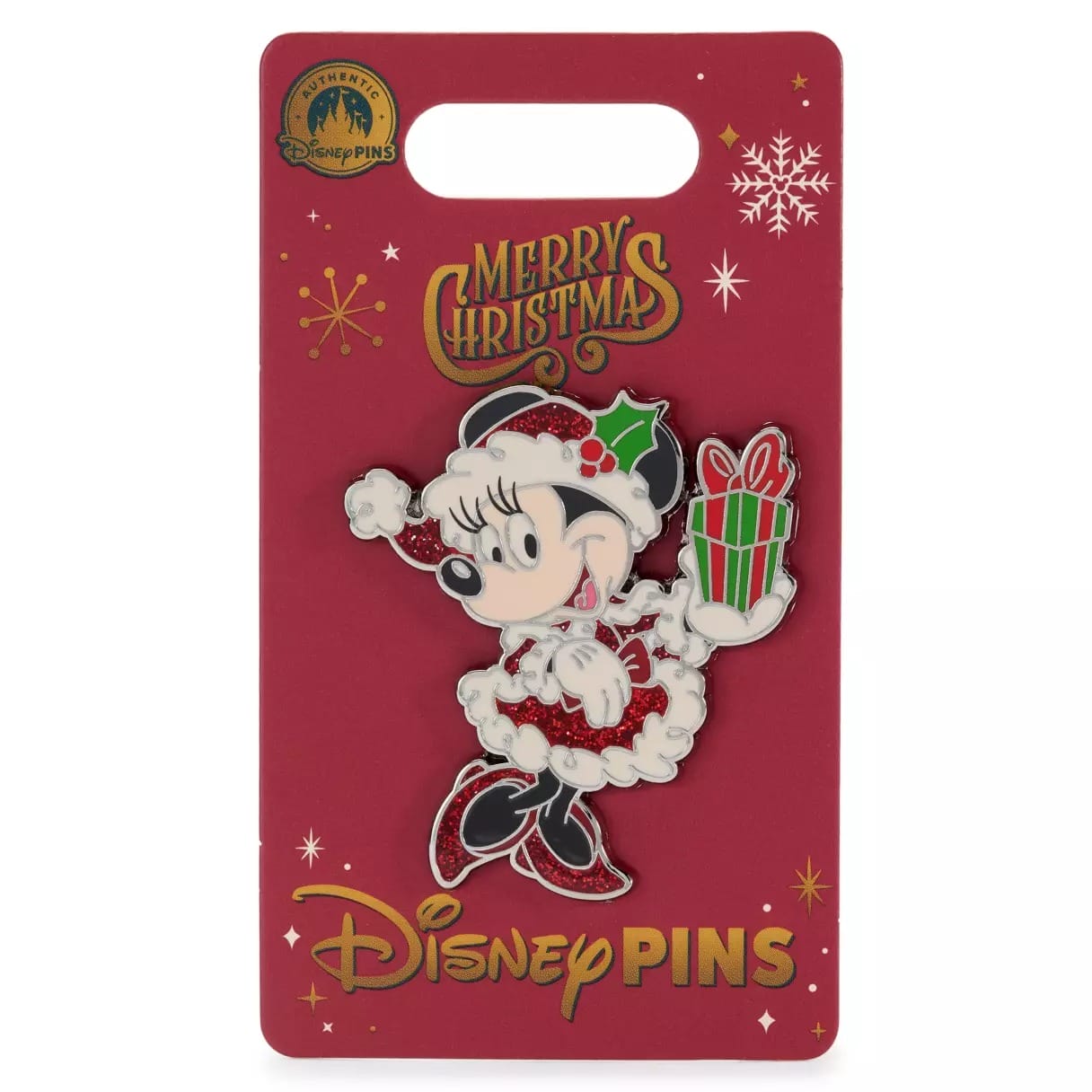 Disney pin of Minnie Mouse in a Christmas outfit holding a gift, on a red backing with "Merry Christmas" text.