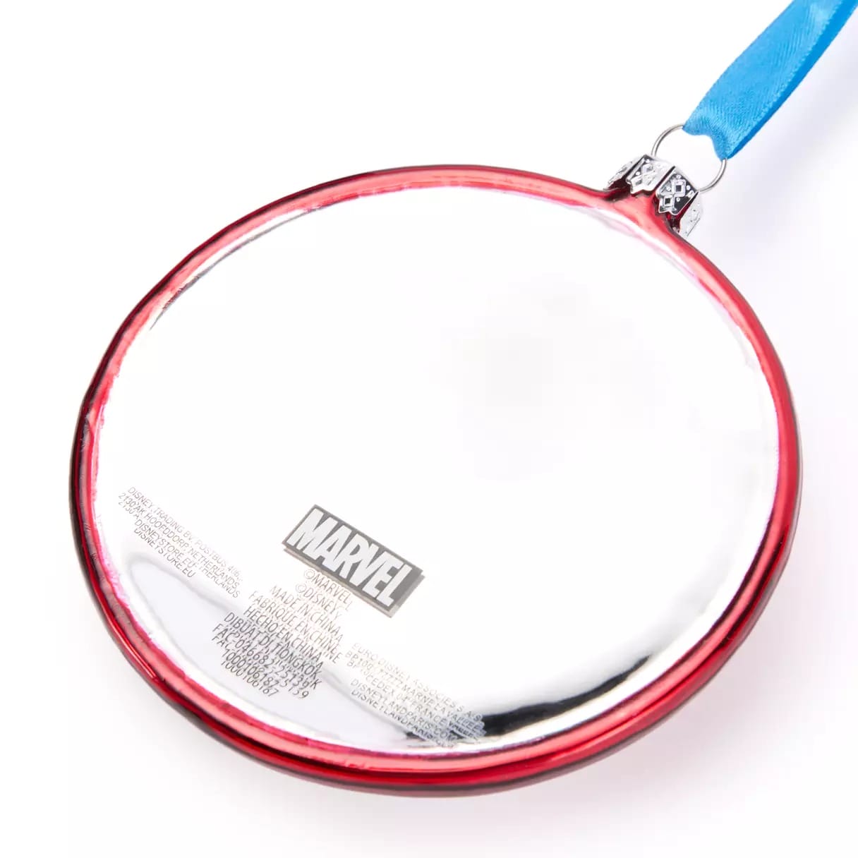 A round metallic object with a Marvel logo, red trim, and a blue strap attached at the top.