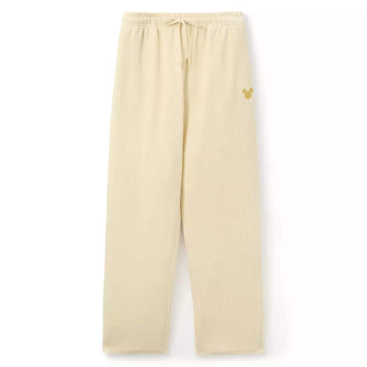Beige ribbed lounge pants with a drawstring waist and a small gold Mickey Mouse head on the left hip.