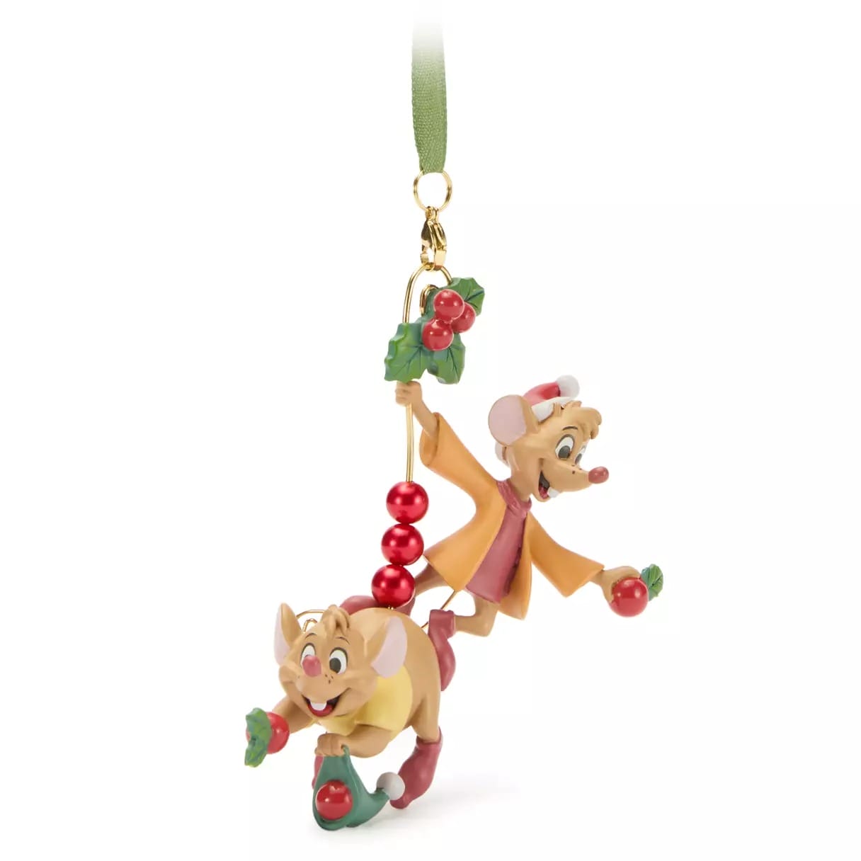 Two cartoon mice in festive clothes hang from a Christmas ornament with holly and red beads, looking joyful.
