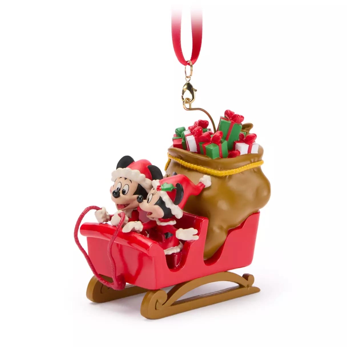 Mickey and Minnie Mouse in a red sleigh ornament with gifts, wearing Santa hats and festive outfits.