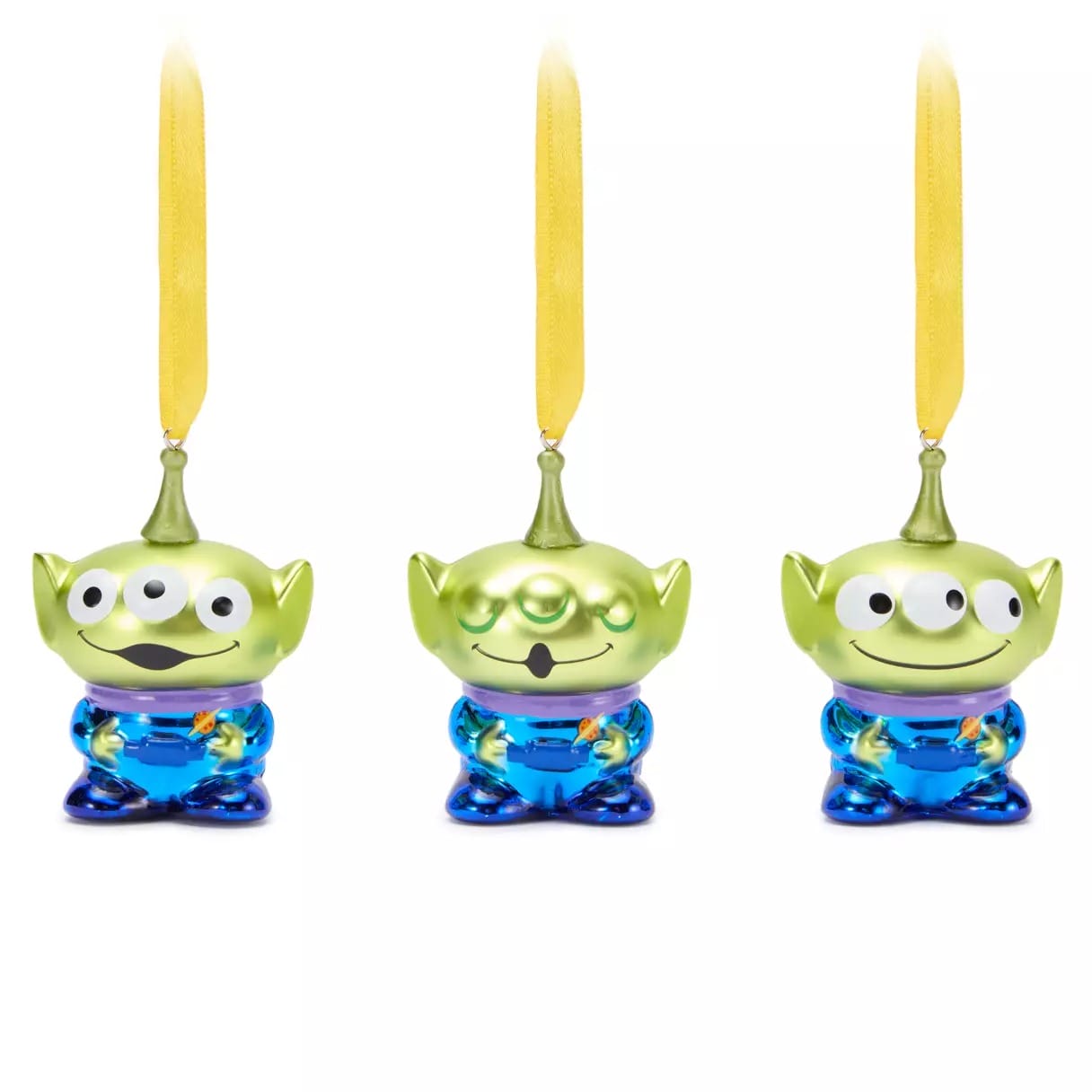 Three green three-eyed alien ornaments with yellow ribbons, blue outfits, and different facial expressions.