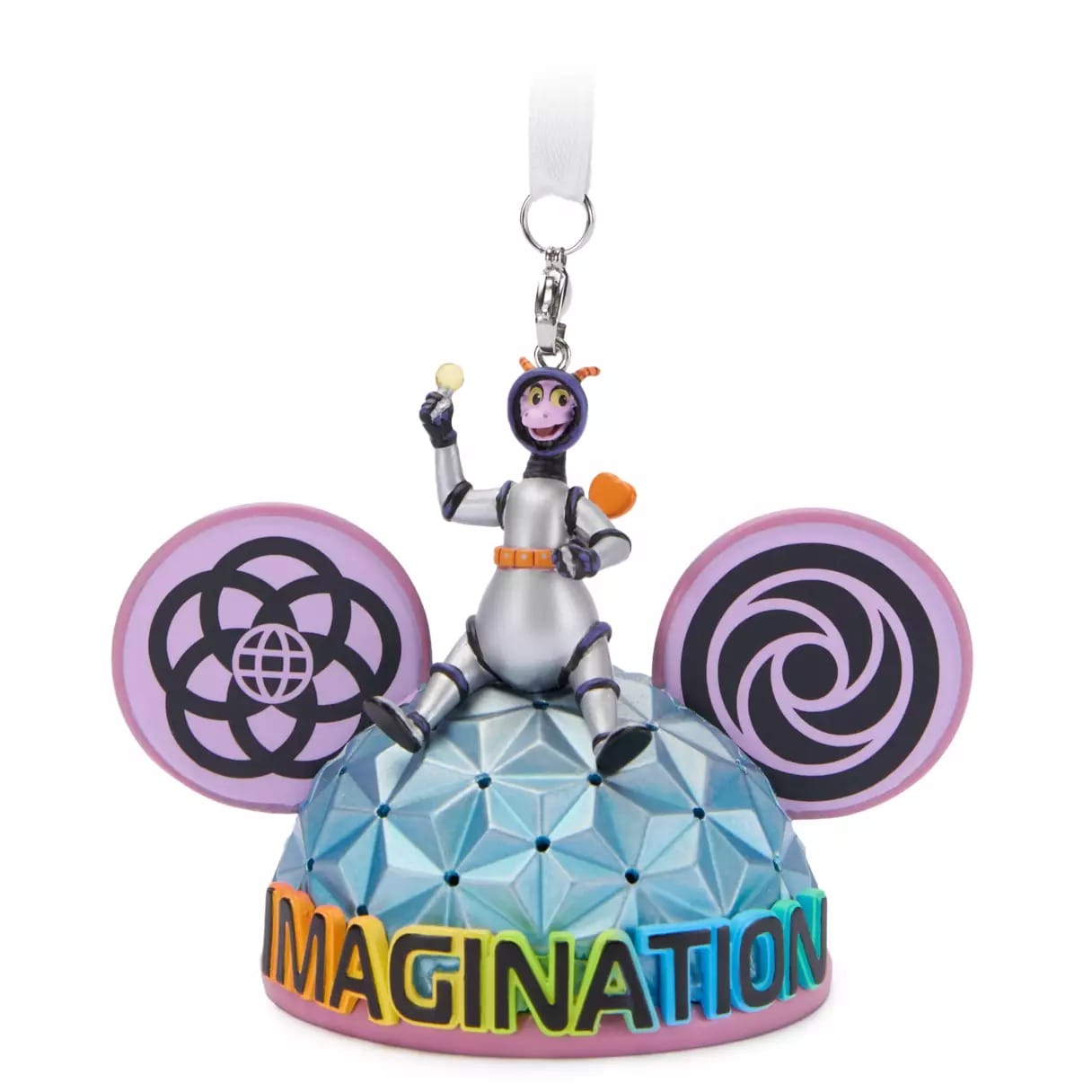 A colorful ornament featuring a purple dragon sitting atop a dome with large pink ears and "IMAGINATION" written in rainbow letters.