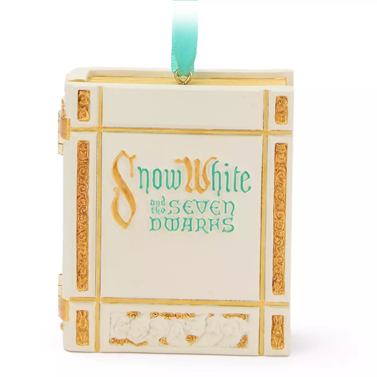 A decorative ornament shaped like a Snow White and the Seven Dwarfs book with gold accents and a teal ribbon.