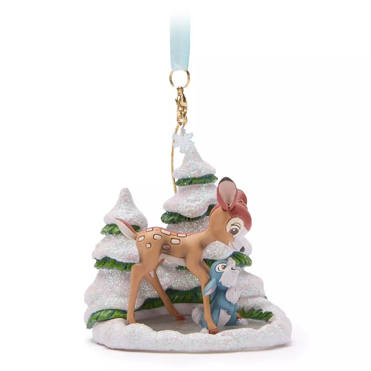Bambi and Thumper ornament stands among snowy, glittery pine trees with a blue ribbon loop for hanging.