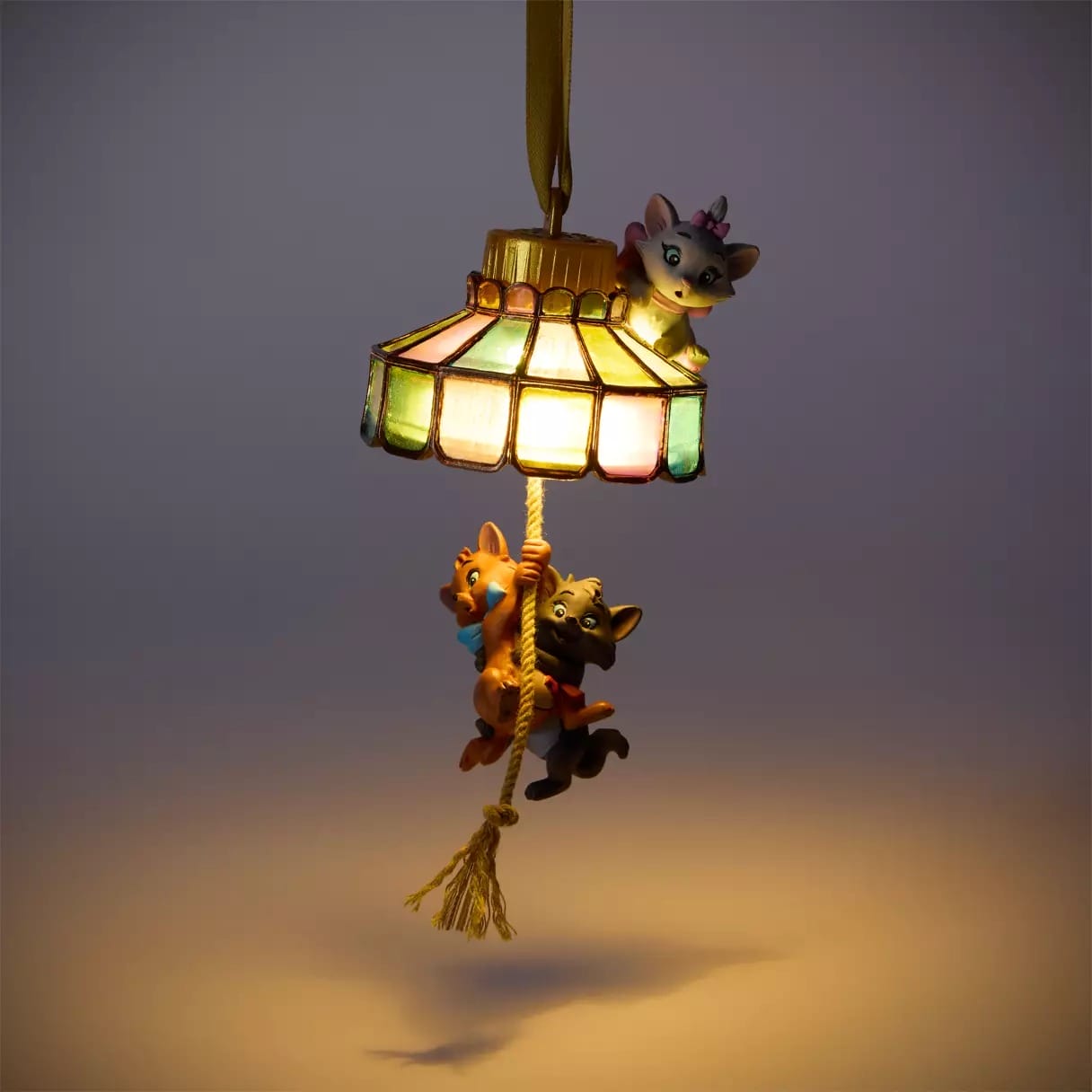 Three cartoon cats on a glowing hanging lamp ornament—a playful 2025 Christmas merchandise from the Disney Store.