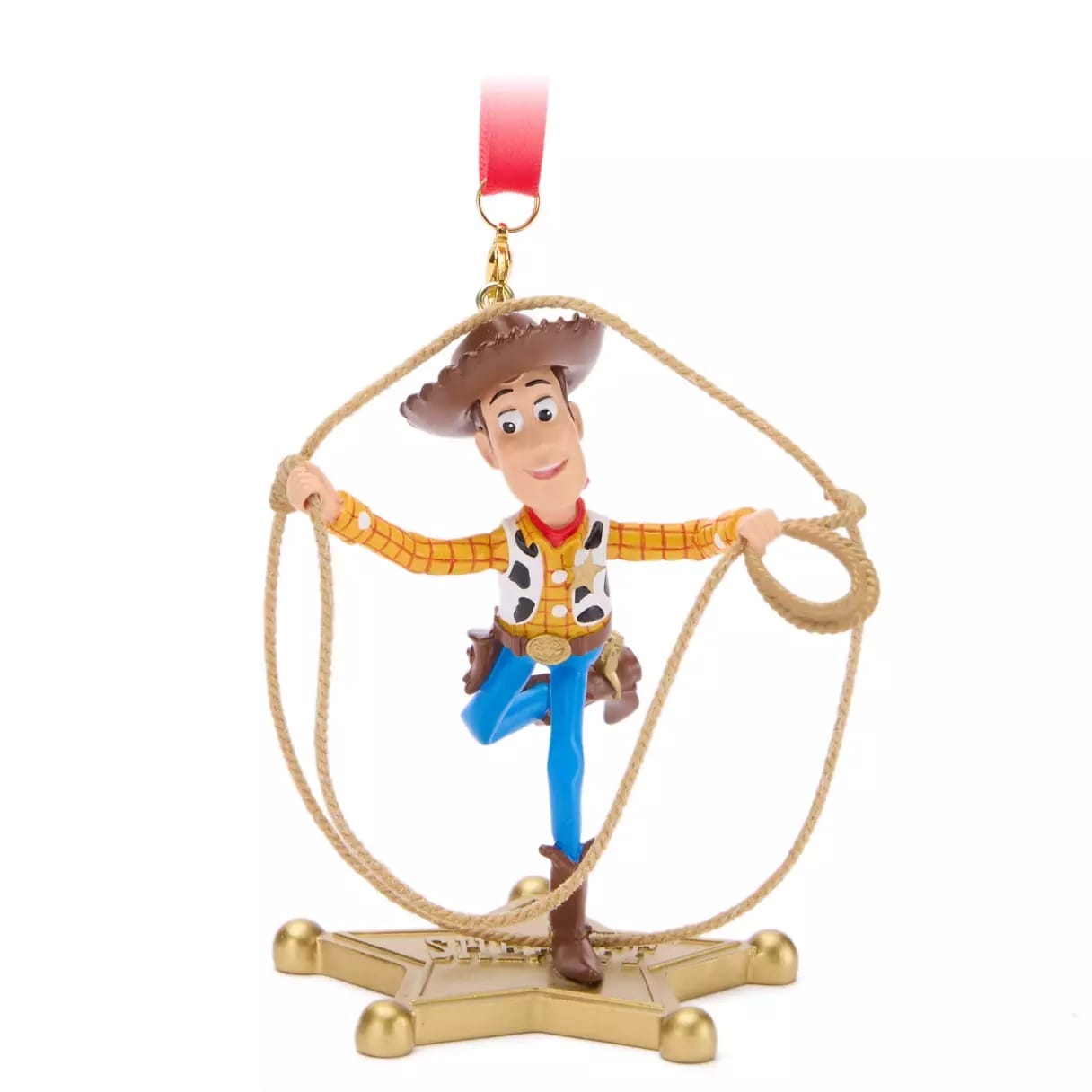 Toy cowboy figurine with a lasso, on a star-shaped base, hangs from a red ribbon—2025 Christmas Merchandise.