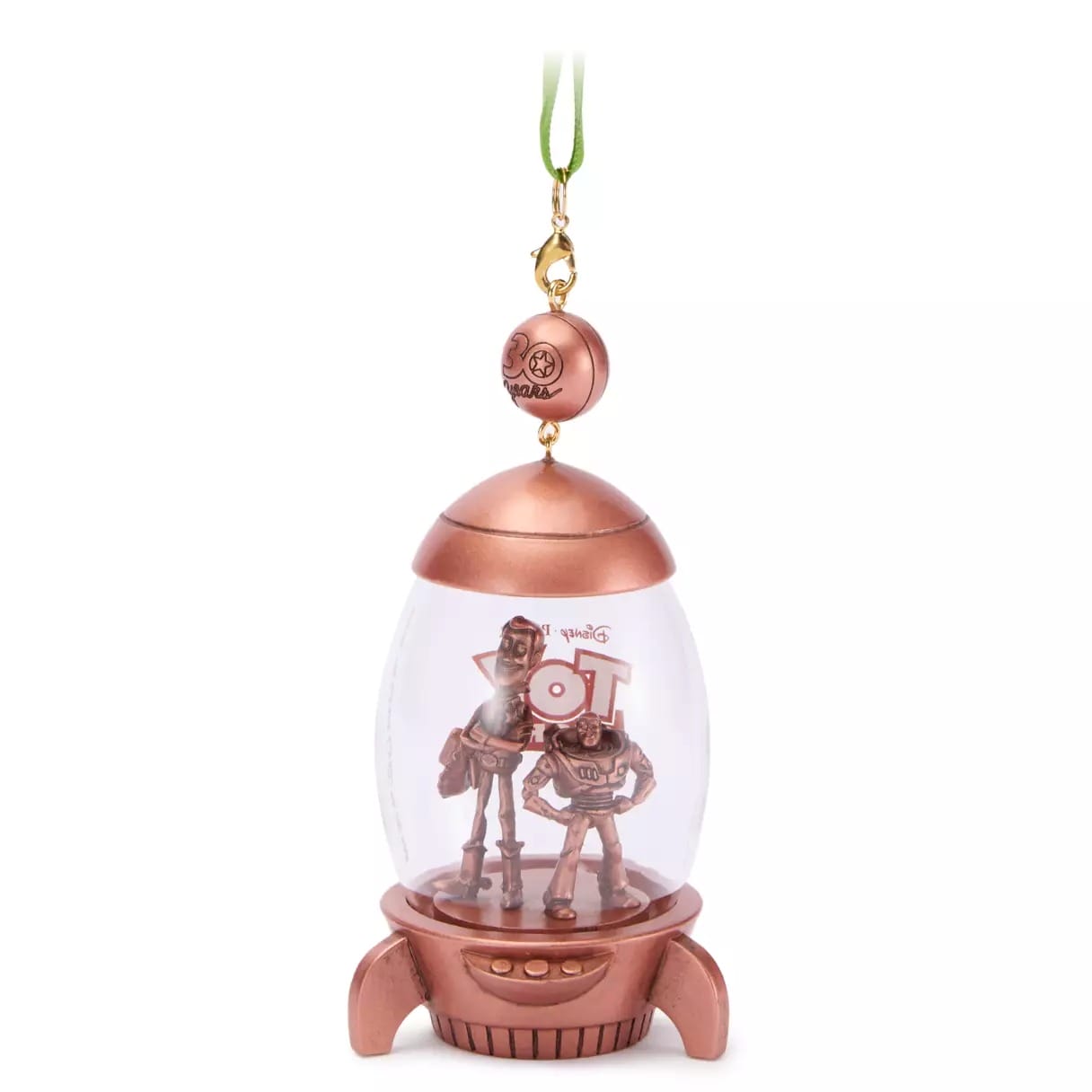 Disney Store 2025 Christmas merchandise: Buzz & Woody robot ornament in a clear capsule with bronze accents and green ribbon.