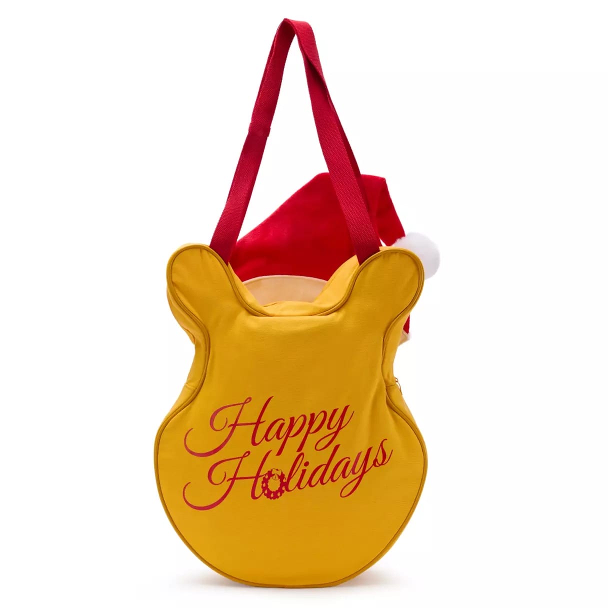 Yellow bear-shaped tote bag with red "Happy Holidays" text and red handles, featuring a Santa hat inside, spotted at Disney Park.